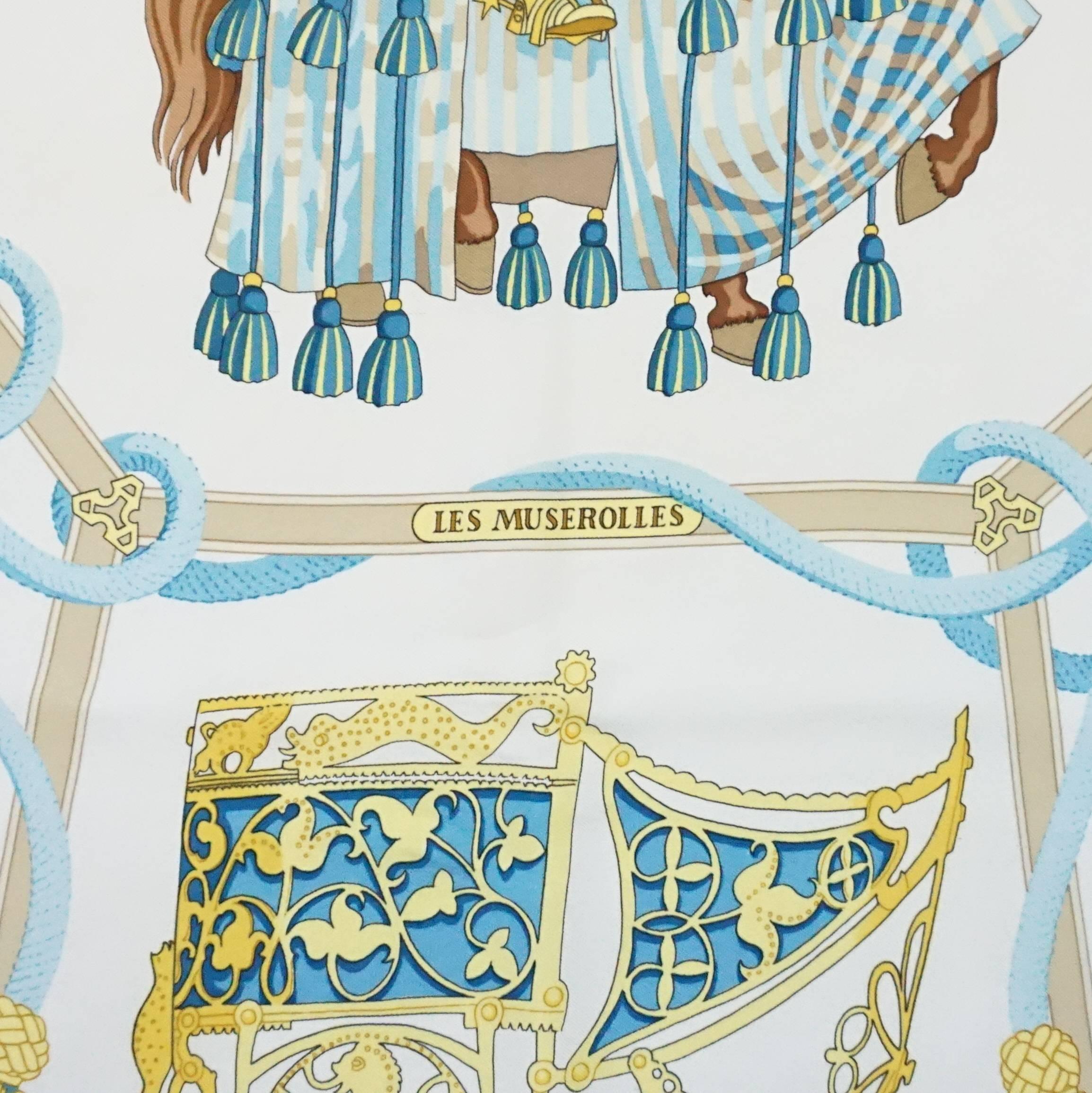 This beautiful vintage Hermes ivory, gold, and blue silk print scarf is a knight print theme known as 