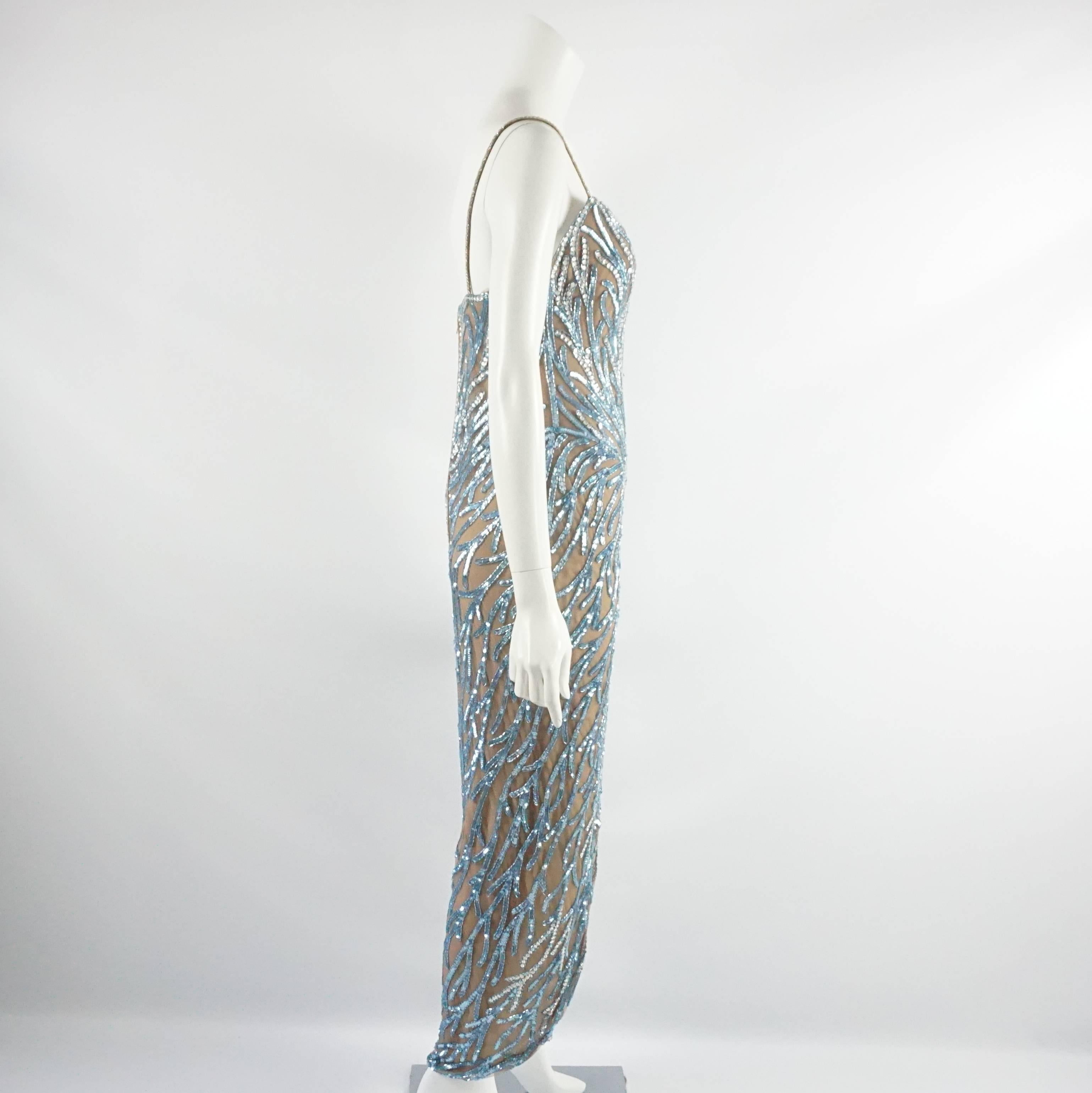 This beautiful vintage Bob Mackie gown has thin spaghetti straps. It is nude mesh and covered with blue beads. There is a zipper in the back and a slit in the center front. This gown is in excellent condition. Circa 1980's, size 8.