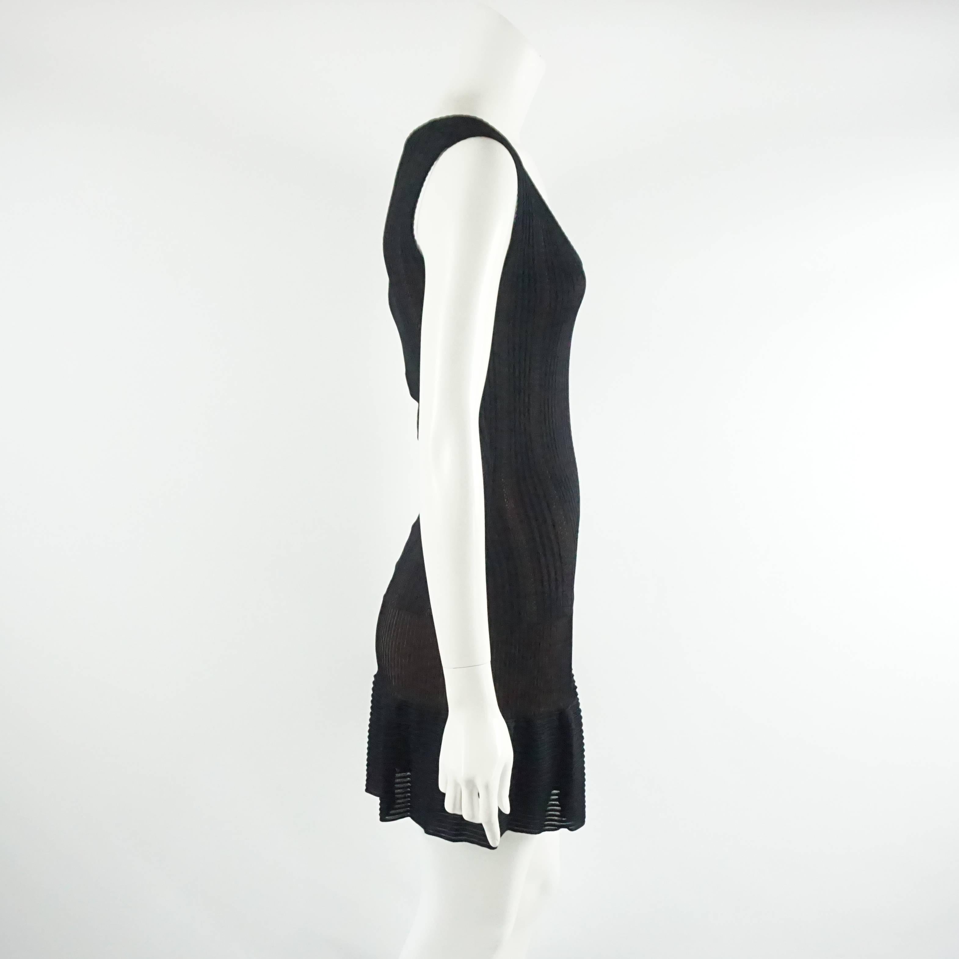 This stunning Azzedine Alaia black knit dress is made of viscose rayon. It is sleeveless with a nude lining and bottom ruffle. The dress is excellent condition with minimal wear. Size XS, circa 2000's. 

Measurements
Shoulder to Shoulder: 15