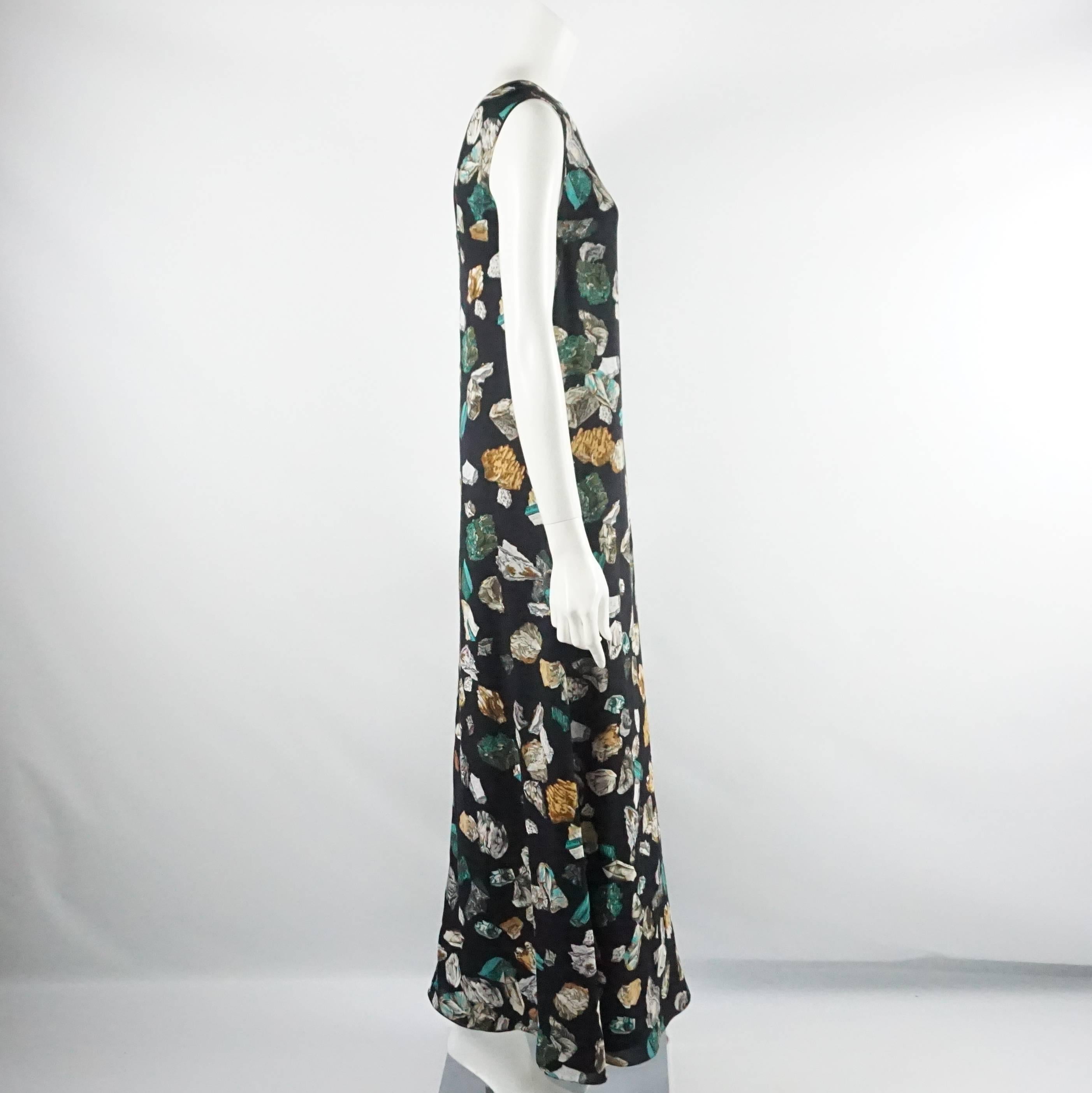 This Hermes maxi dress is brand new with tags and was a runway piece in Fall 2013. This dress is black crepe with a stone print and titled "Mineraux." It has a round neck and deep "V" back with a effortlessly flowy look. Size 36,