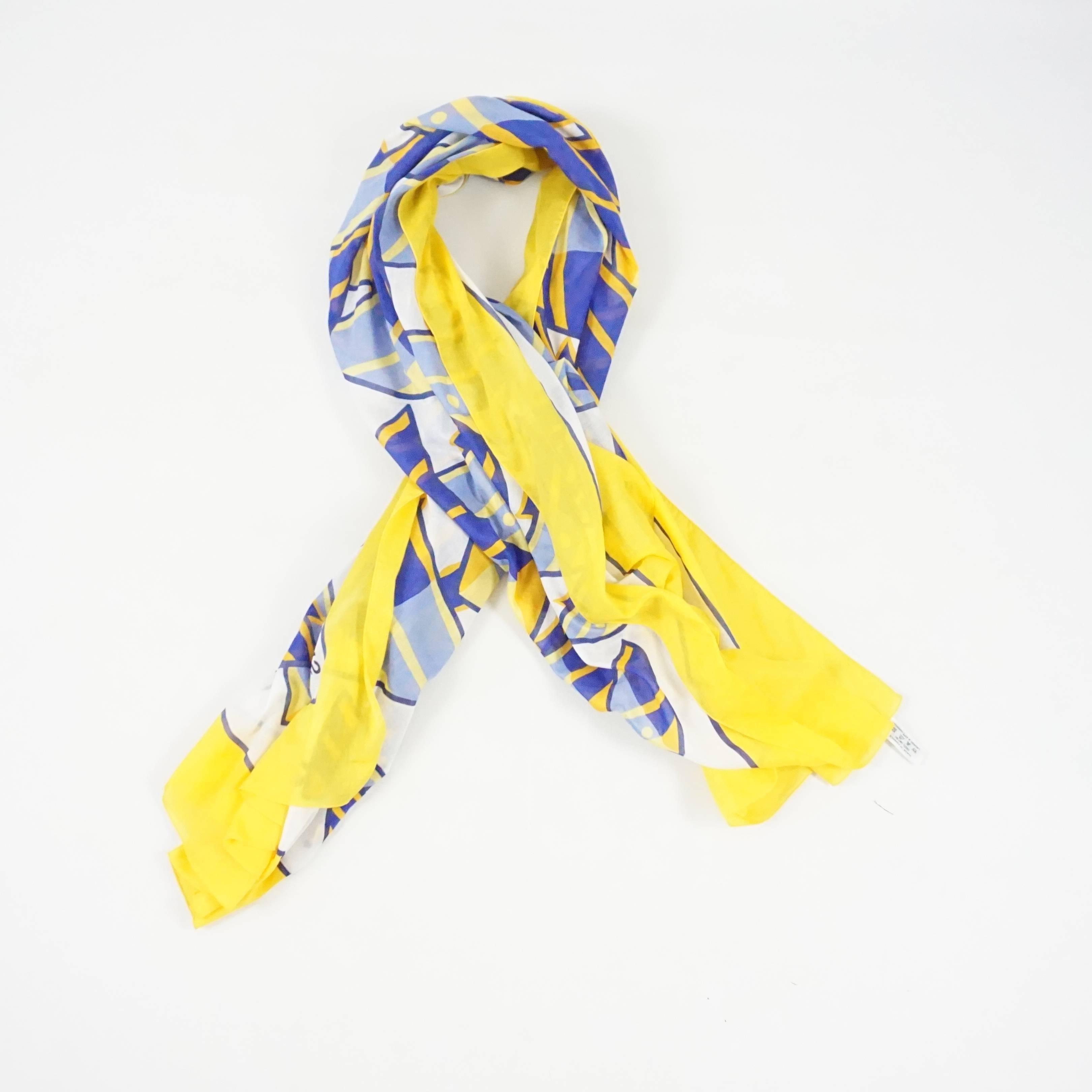This fun Hermes shawl / pareo is blue, white, and yellow. It has a fish design. This piece can be worn as either a shawl or a pareo (see last images). It is in excellent condition.

Measurements
Height: 58.5"
Length: 68.5"