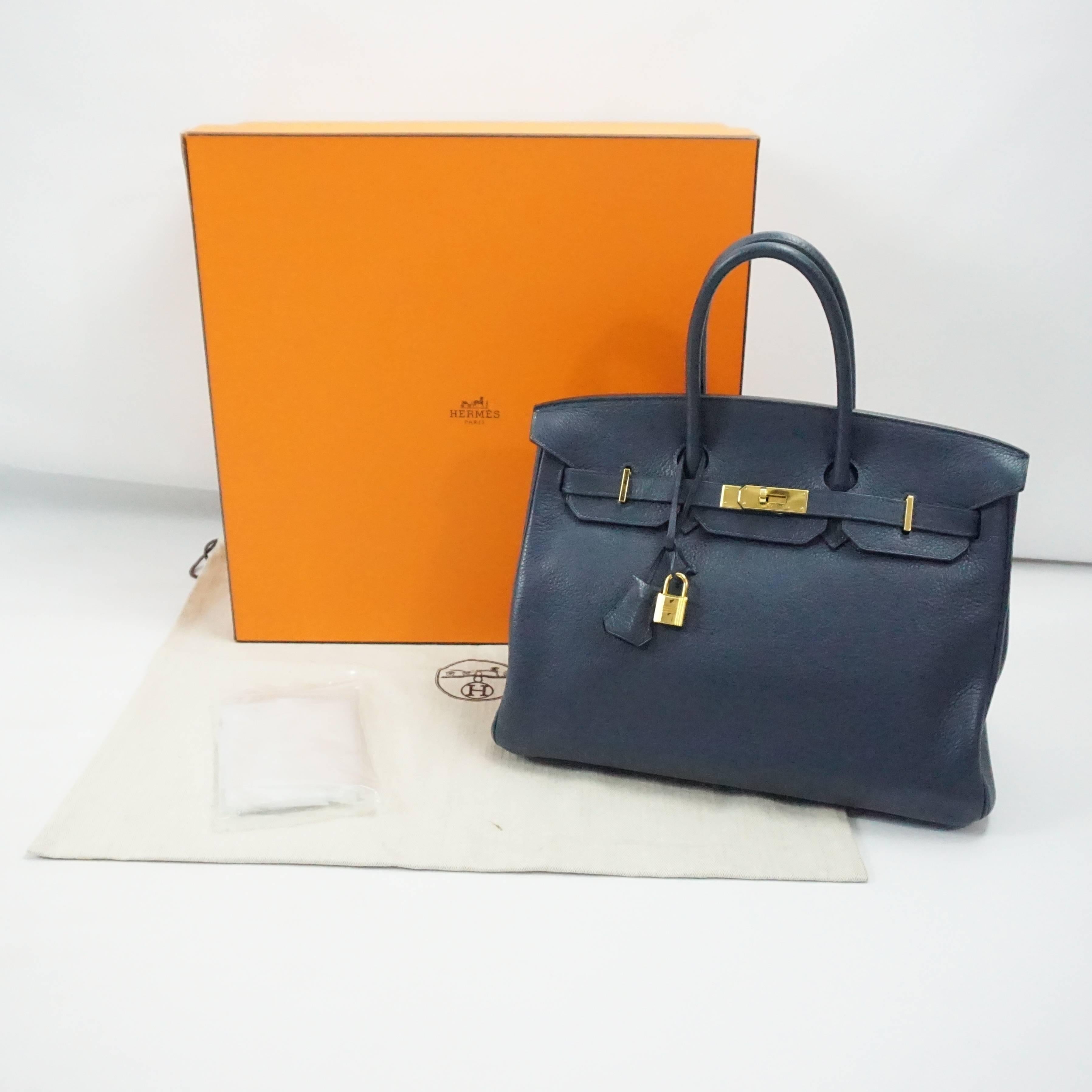 This gorgeous 35cm Hermes Birkin is made of navy clemence leather and has shining gold hardware. It comes with its raincoat, duster, and box. This bag is in excellent condition.

Measurements
Height: 9.8"
Length: about 13.75"
Depth: 7"