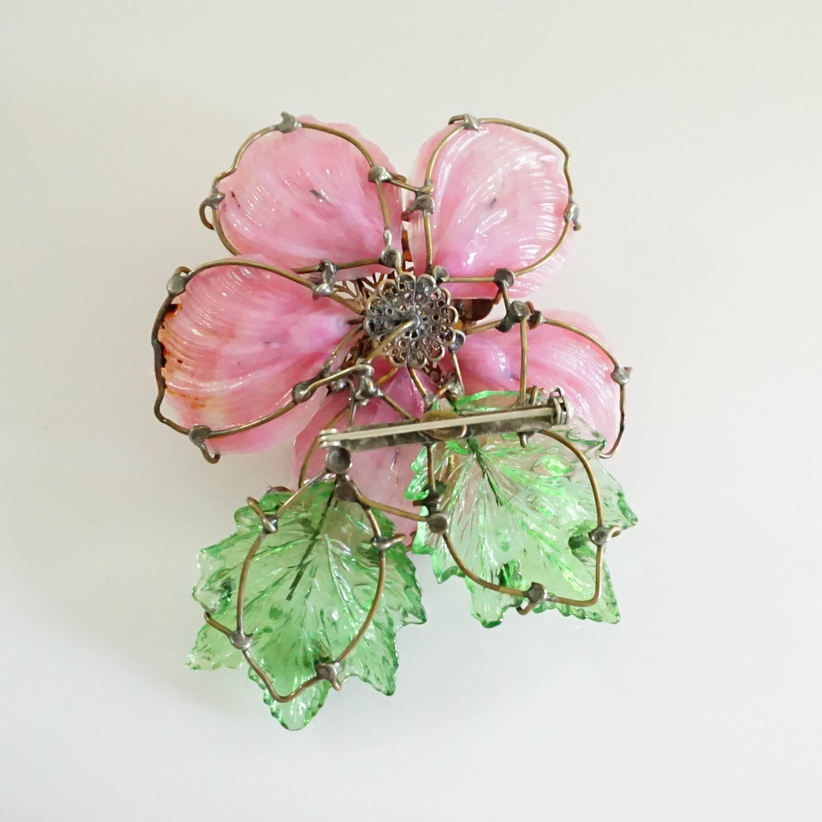 This Lawrence Vrba flower brooch is pink with green leaves. Around the center is a circle of pearls and surrounding the leaves and petals are rhinestones. This brooch is in very good condition with wear consistent with the age.

Measurements
Height