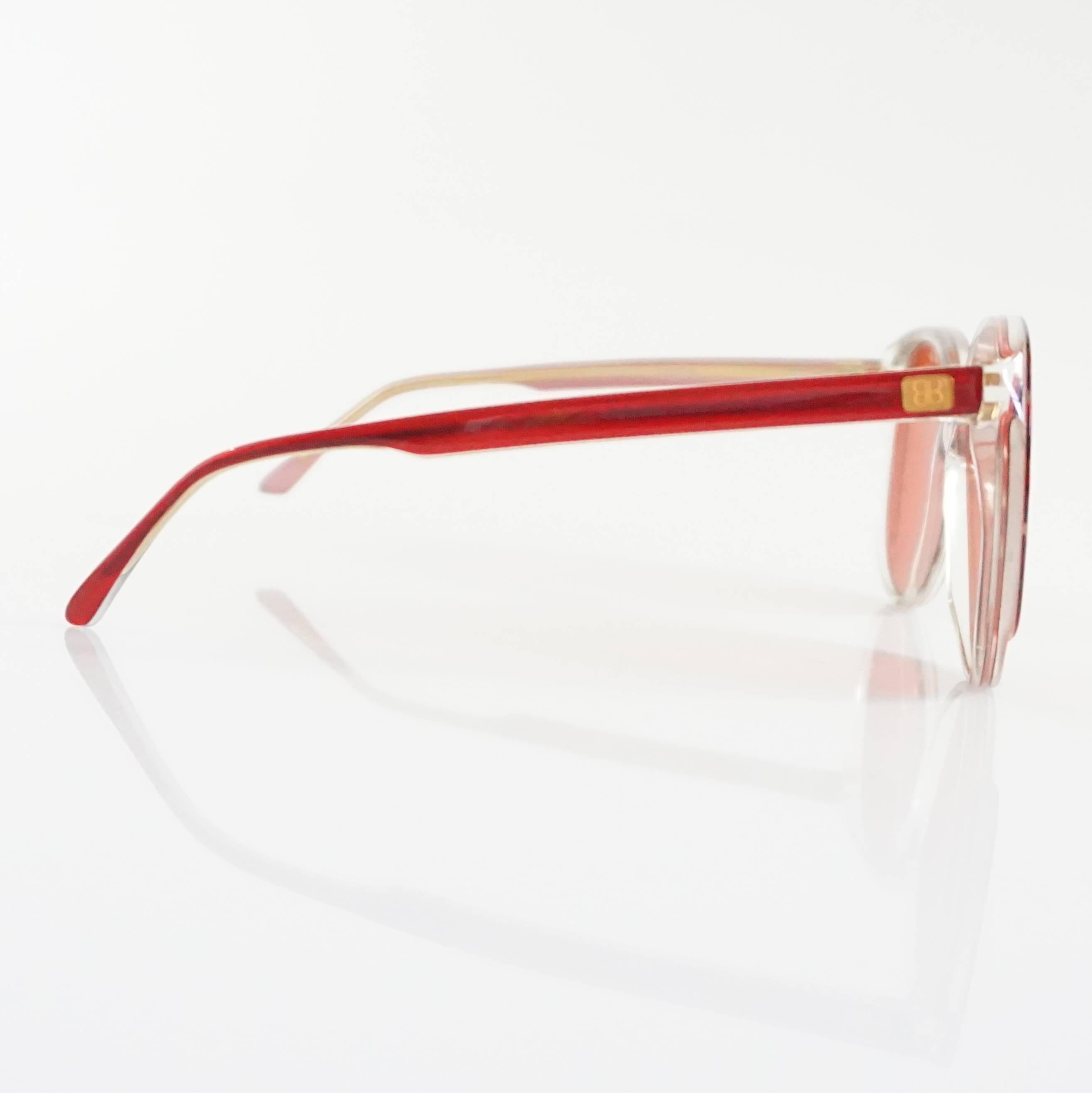 These fun Balenciaga sunglasses have red lenses and a red and clear Lucite frame. They are in excellent condition. Circa 1980's. 

Measurements
Leg Length: 5.25