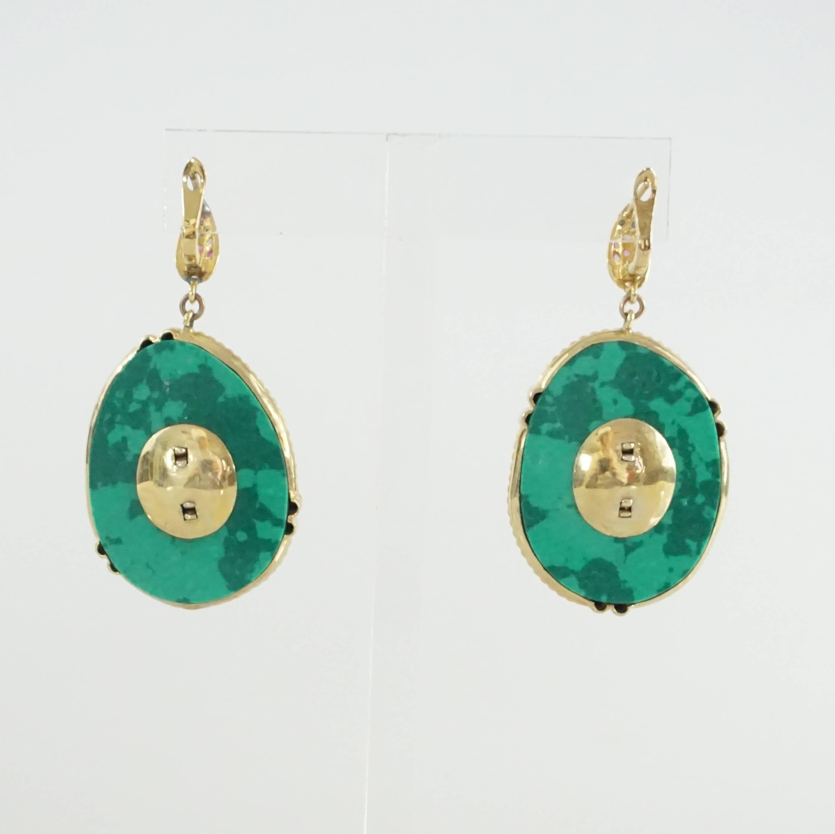 These stunning earrings are the perfect pop of color! They were bought from Christina's South Seashells and have a teal malachite back with 2% gold vermeil and yellow and pink sapphires all around. The earrings are in excellent condition with very