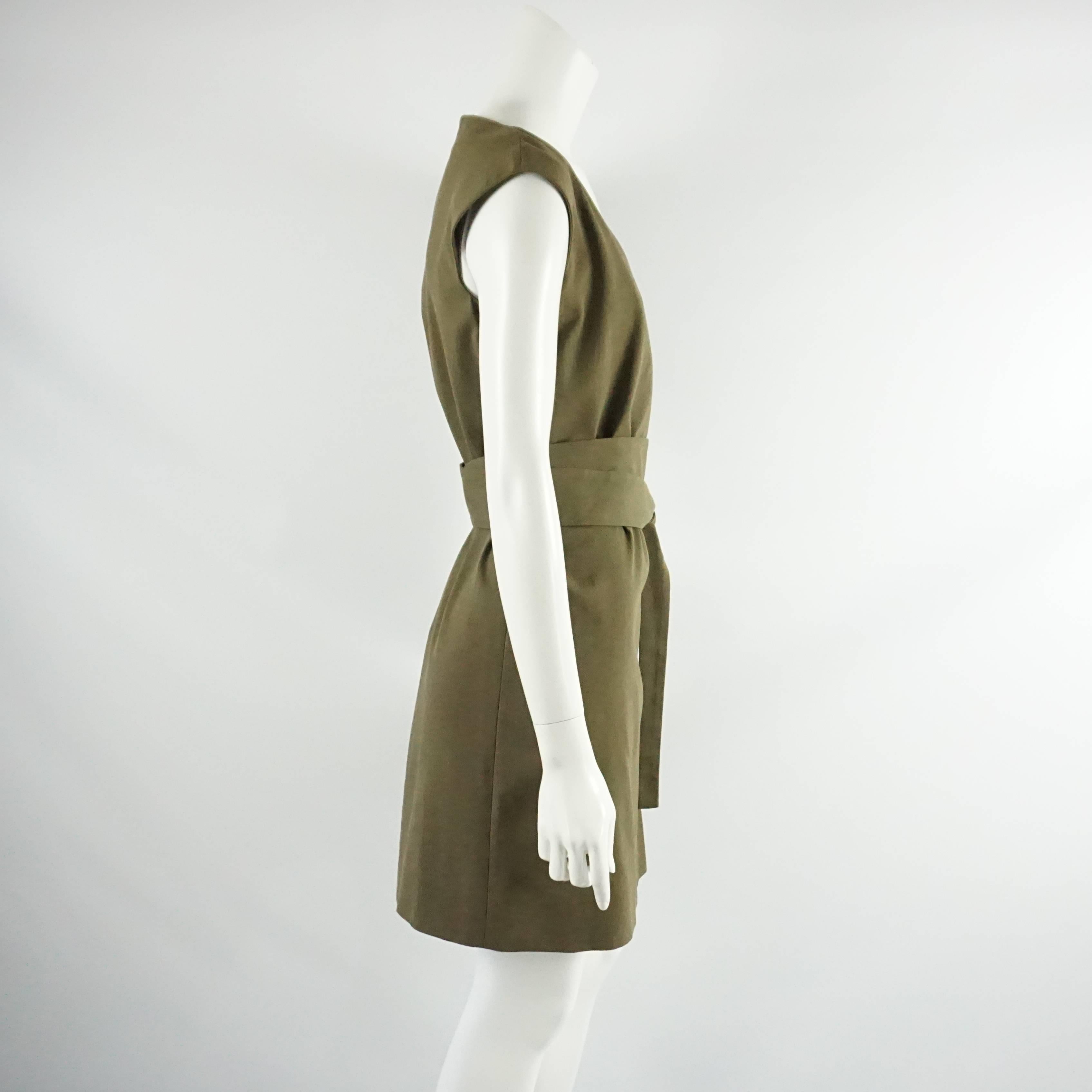 This Gucci dress is made of army green/olive cotton and has a shift style. It features a v-neck and a sash. This dress is in good condition with some staining on the dress and rust on the sash metal opening.

Dress Measurements
Sleeve Length: