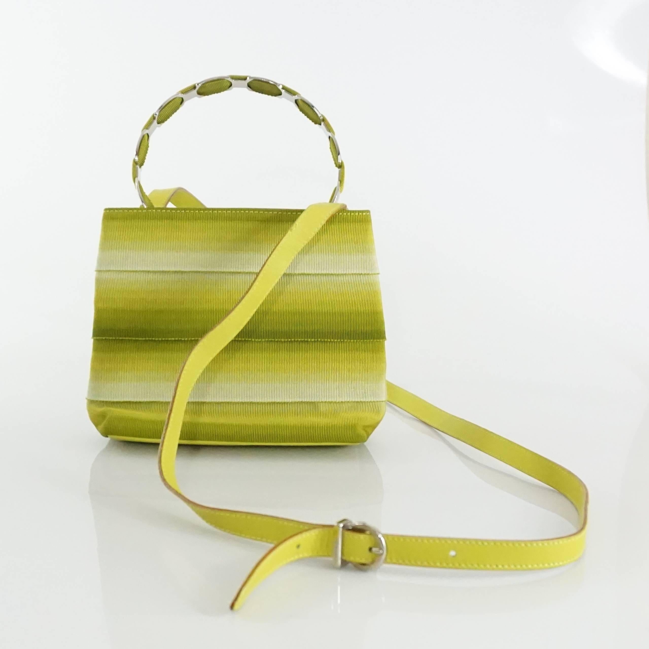This Salvatore Ferragamo handbag is chartreuse and gros grain with a top handle. There is also an included crossbody strap and a silver closure. This bag is in very good condition with minor wear on the strap.

Measurements
Length: 6.75