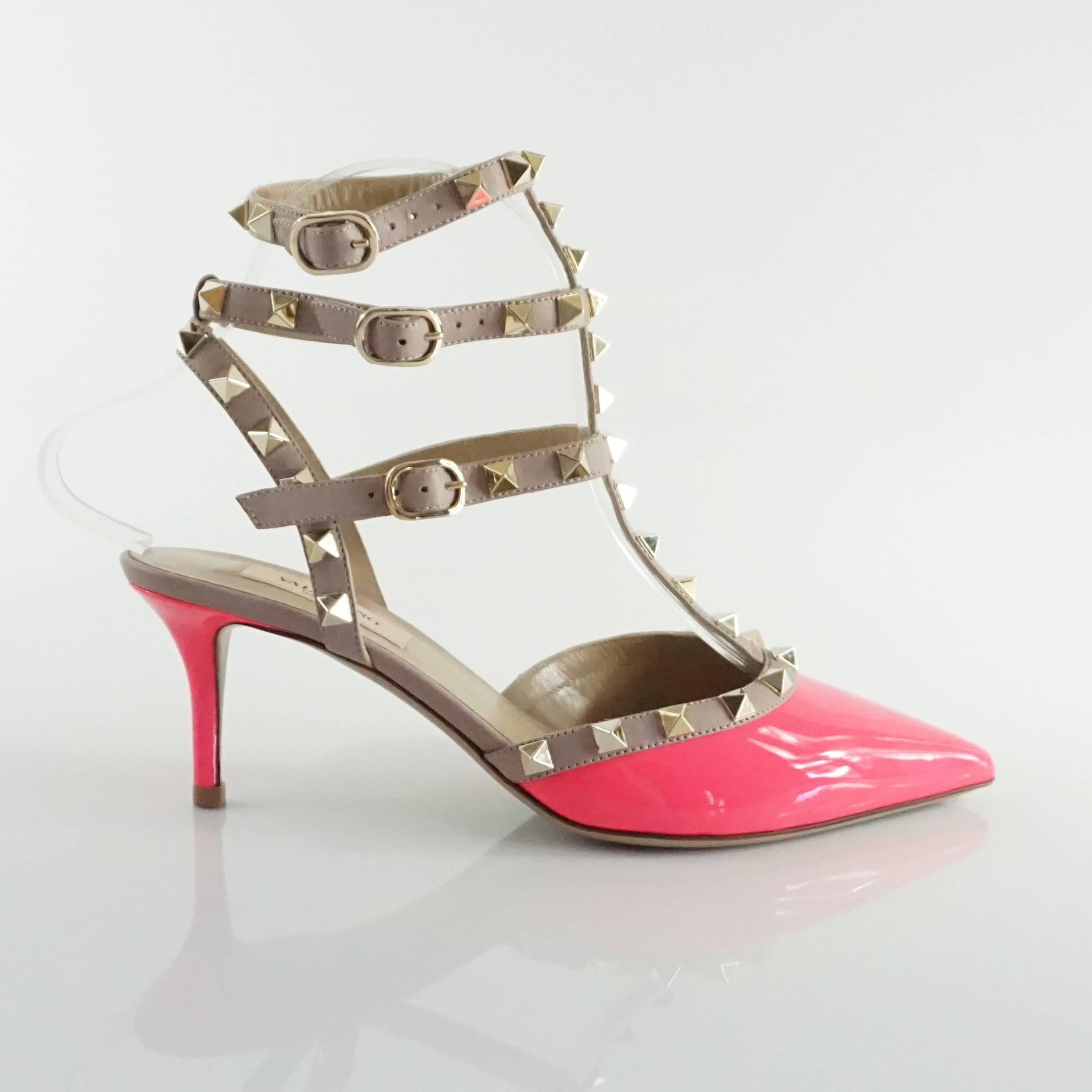 These Valentino heels are neon pink and taupe patent leather with rock studs. They features a pointed toe, a kitten heel, and ankle strap covered in rock studs. These shoes are in excellent condition.

Heel Height: 2.75"