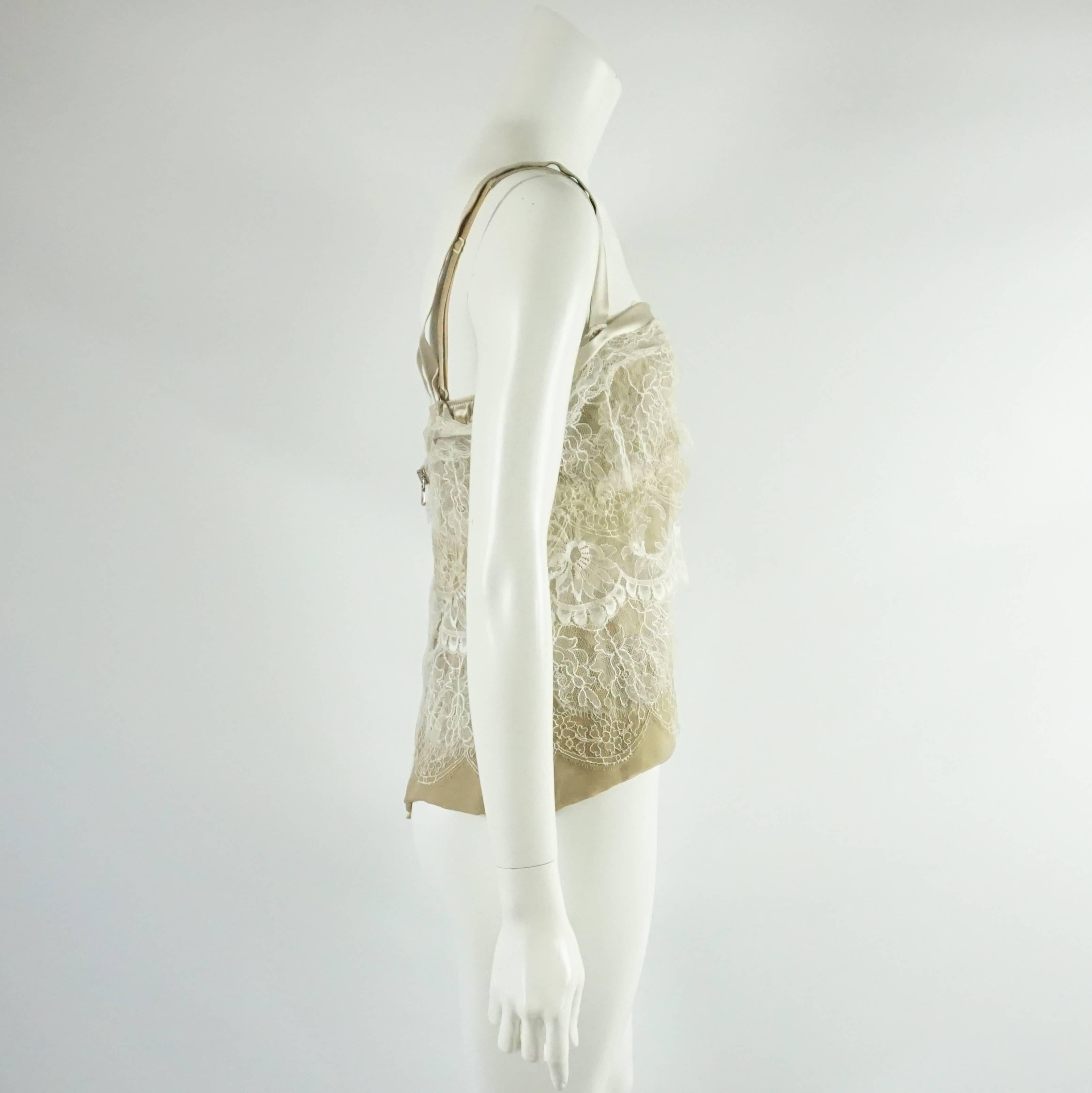This Dolce & Gabbana camisole has a built-in bra and is tan with ivory lace. It has a silk trim. This camisole is in excellent condition.

Measurements
Bust: 33