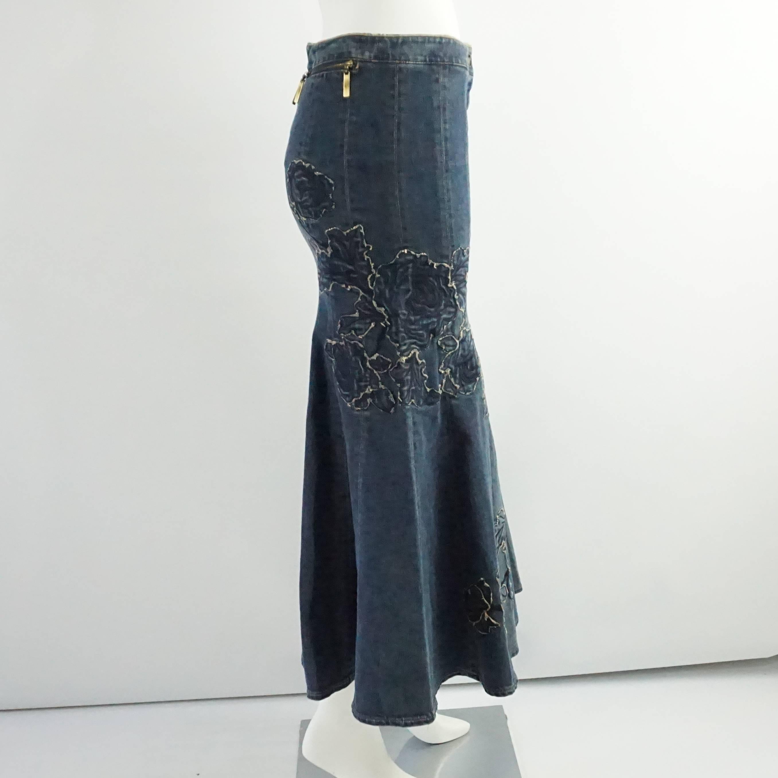 This Roberto Cavalli denim skirt is fitted and then flares out. It features an embroidered rose design and 2 back pockets. Each pocket has 2 zipper pulls. This skirt is in excellent condition.

Measurements
Waist: 30