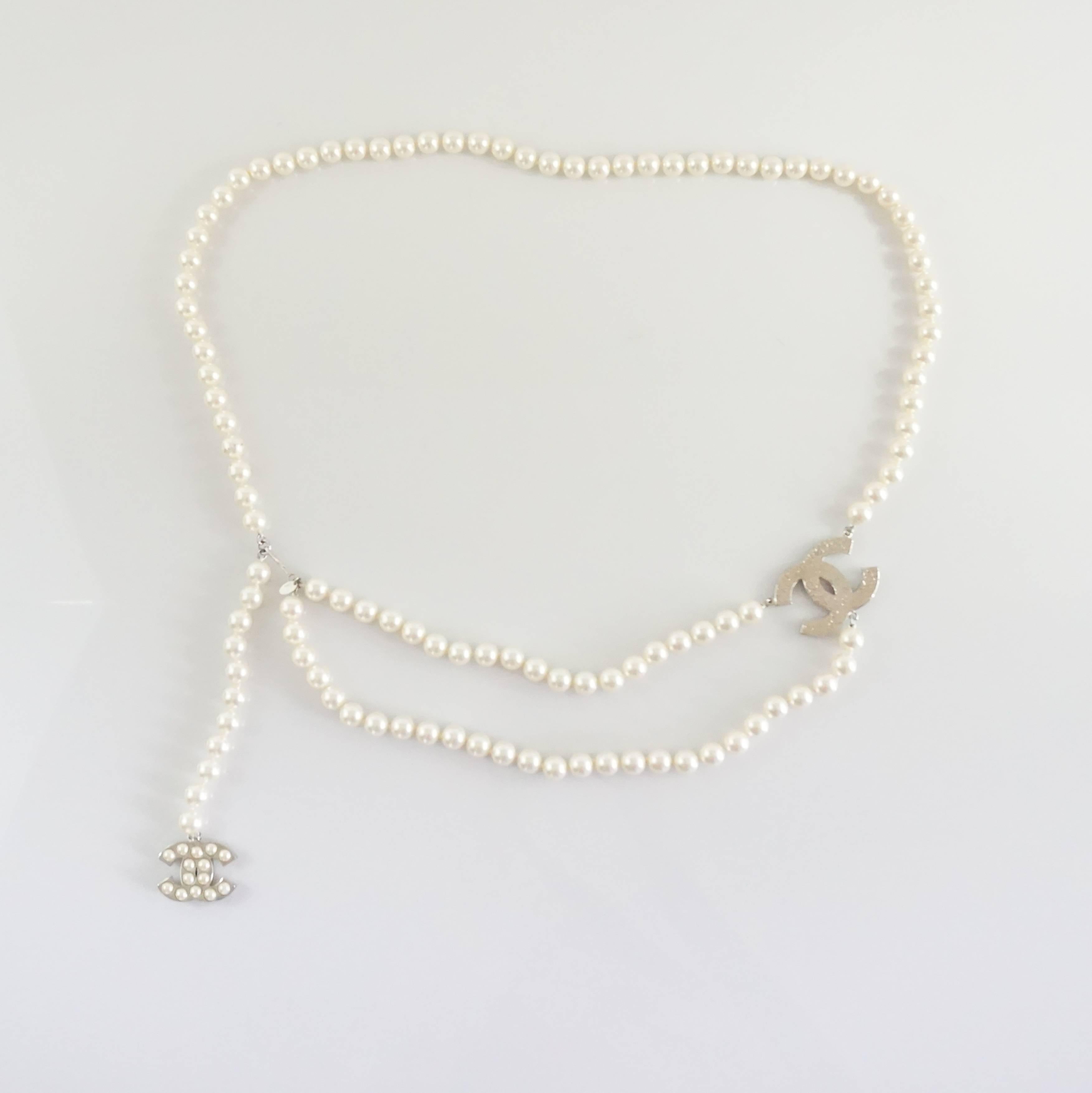 This Chanel pearl necklace also doubles as a belt. It is long with a big pearl encrusted CC in the middle and a hanging pearl CC charm on the end. The necklace is in impeccable condition and is brand new. 

Measurements
Length: 42