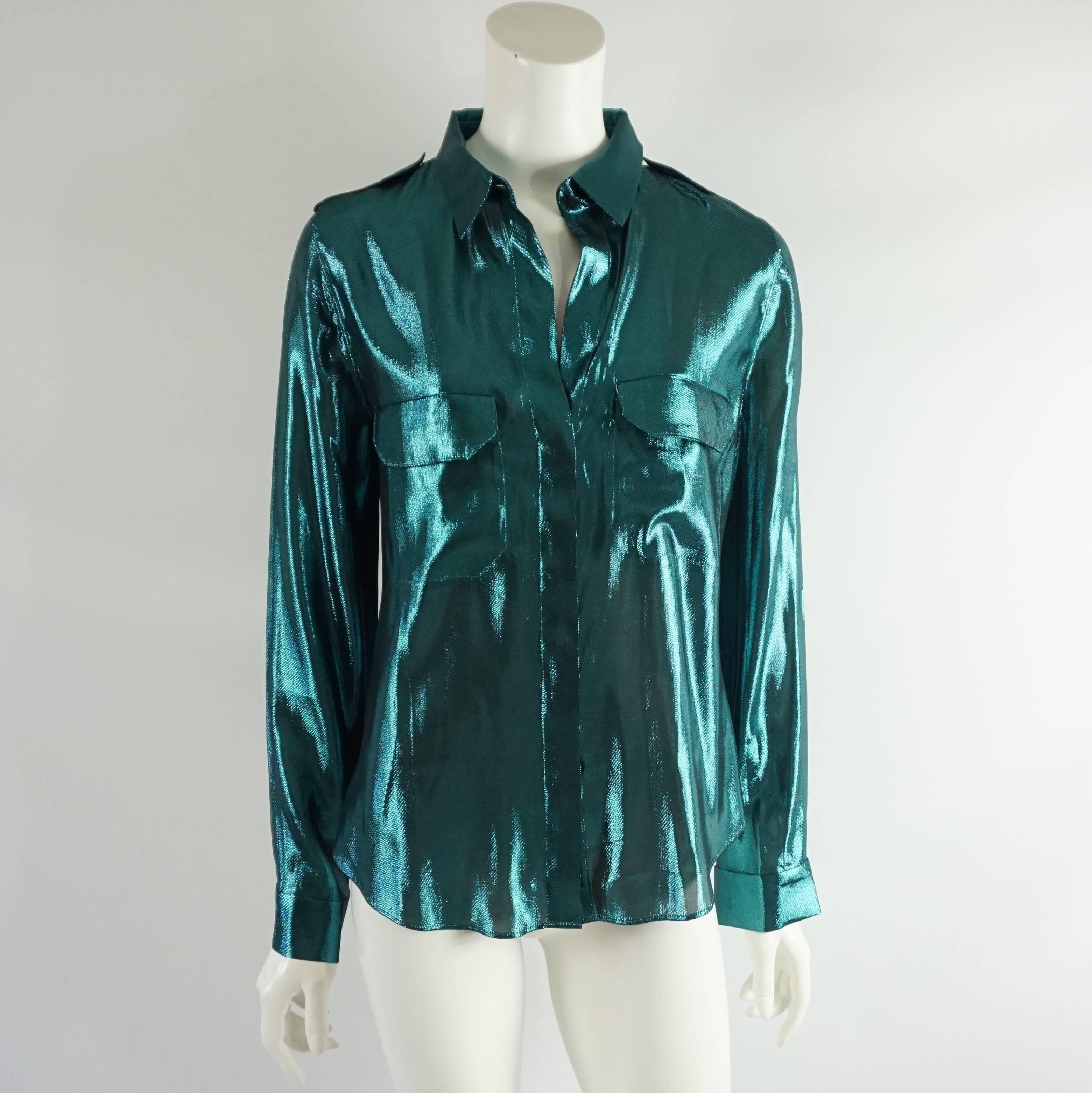 This Lanvin silk lame shirt is an eye-catching metallic teal color. There are 2 front pockets, both with a flap, and hidden buttons going down the front. This shirt is in excellent condition.

Measurements
Shoulder to Shoulder: 15.75