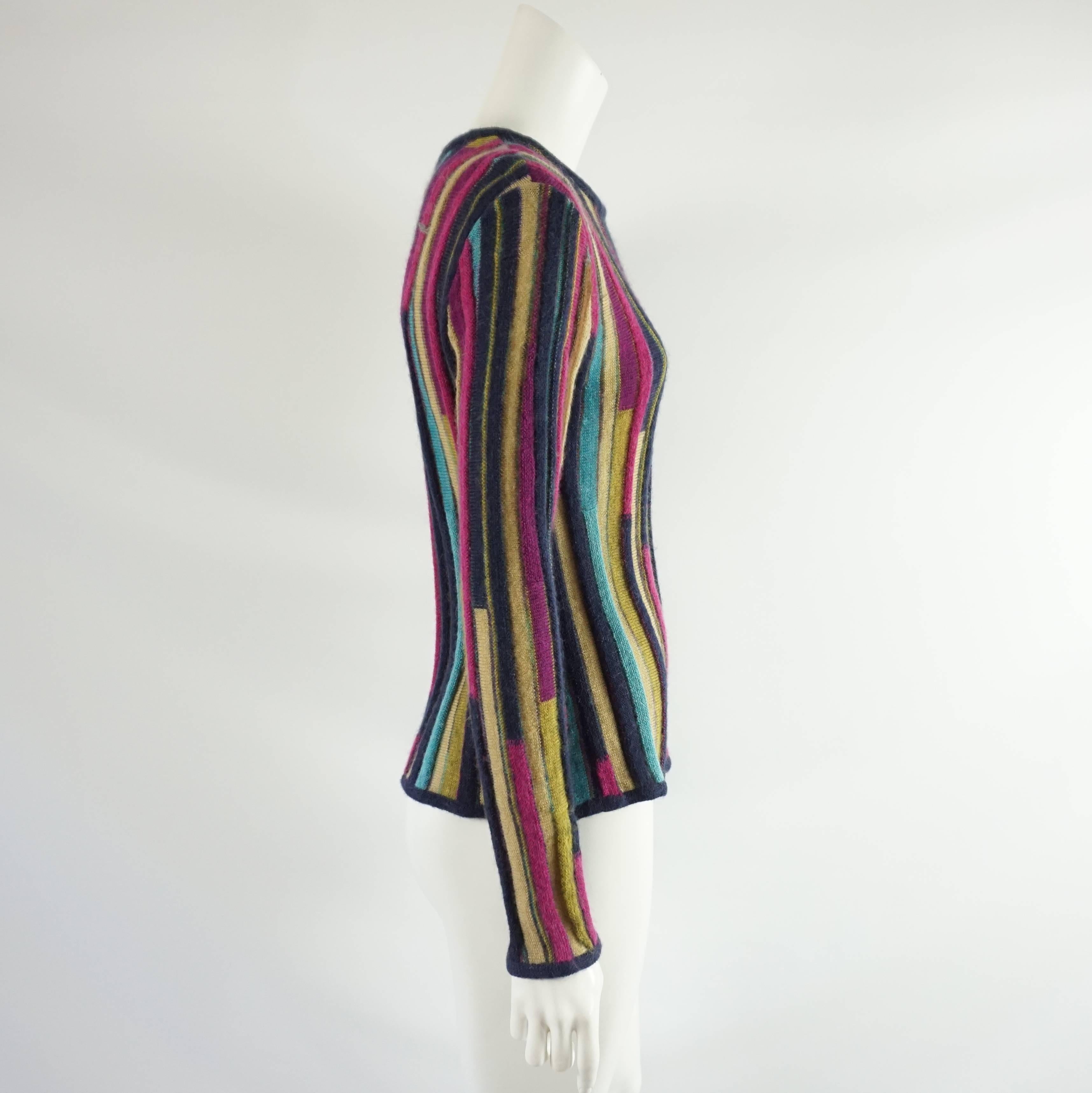 This Missoni mohair sweater is long sleeved with vertical stripes in many colors. Some of the stripes have a ribbed feeling. This sweater is in excellent condition. Size medium.

Measurements
Shoulder to Shoulder: 17.25