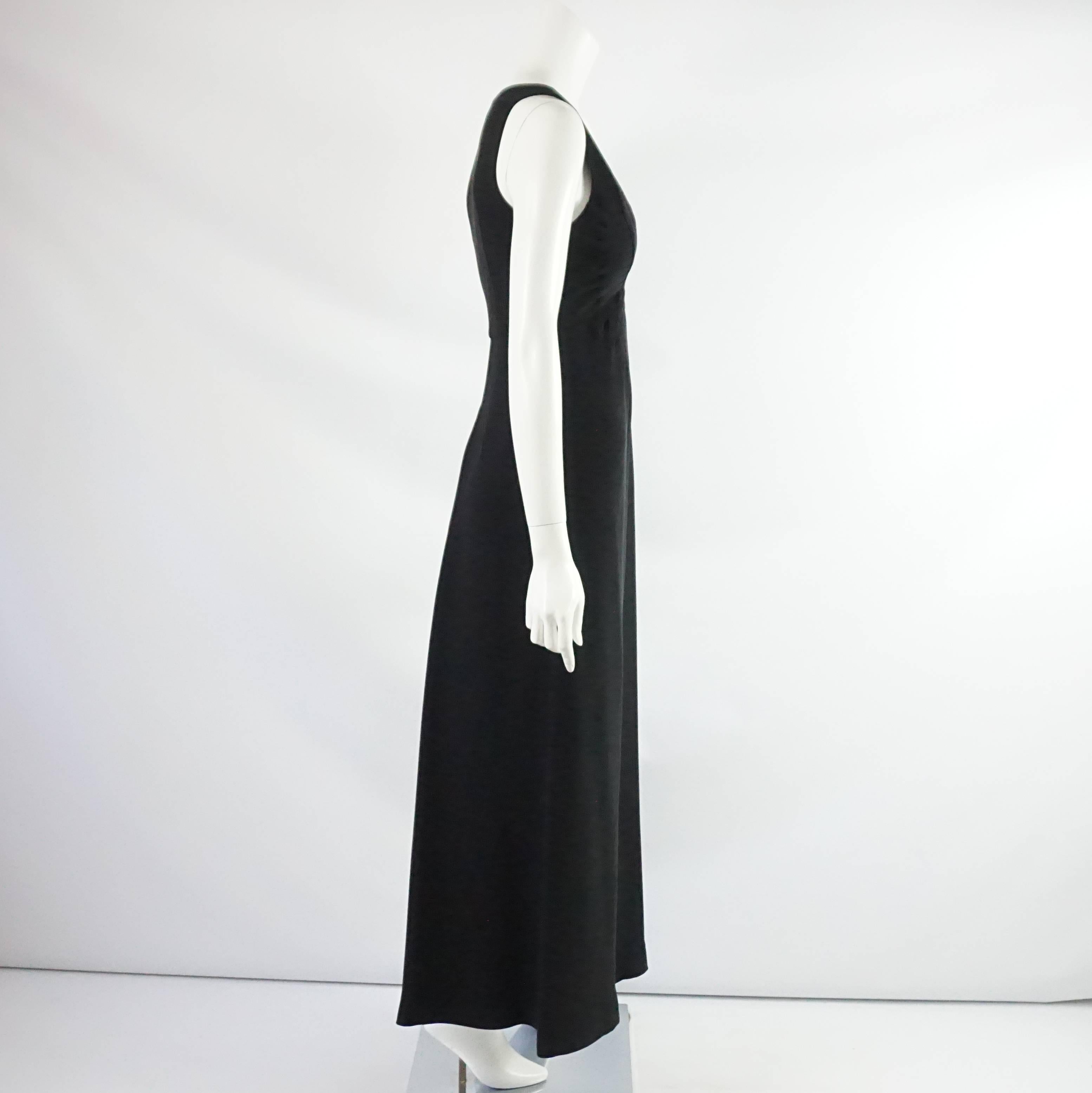 This Valentino palazzo pant jumpsuit is sleeveless. It features a v-neck and front pleating. Inside, there are attached push-up bra cups. This jumpsuit is in excellent condition with some very minor discoloration / staining and pulled threads at the