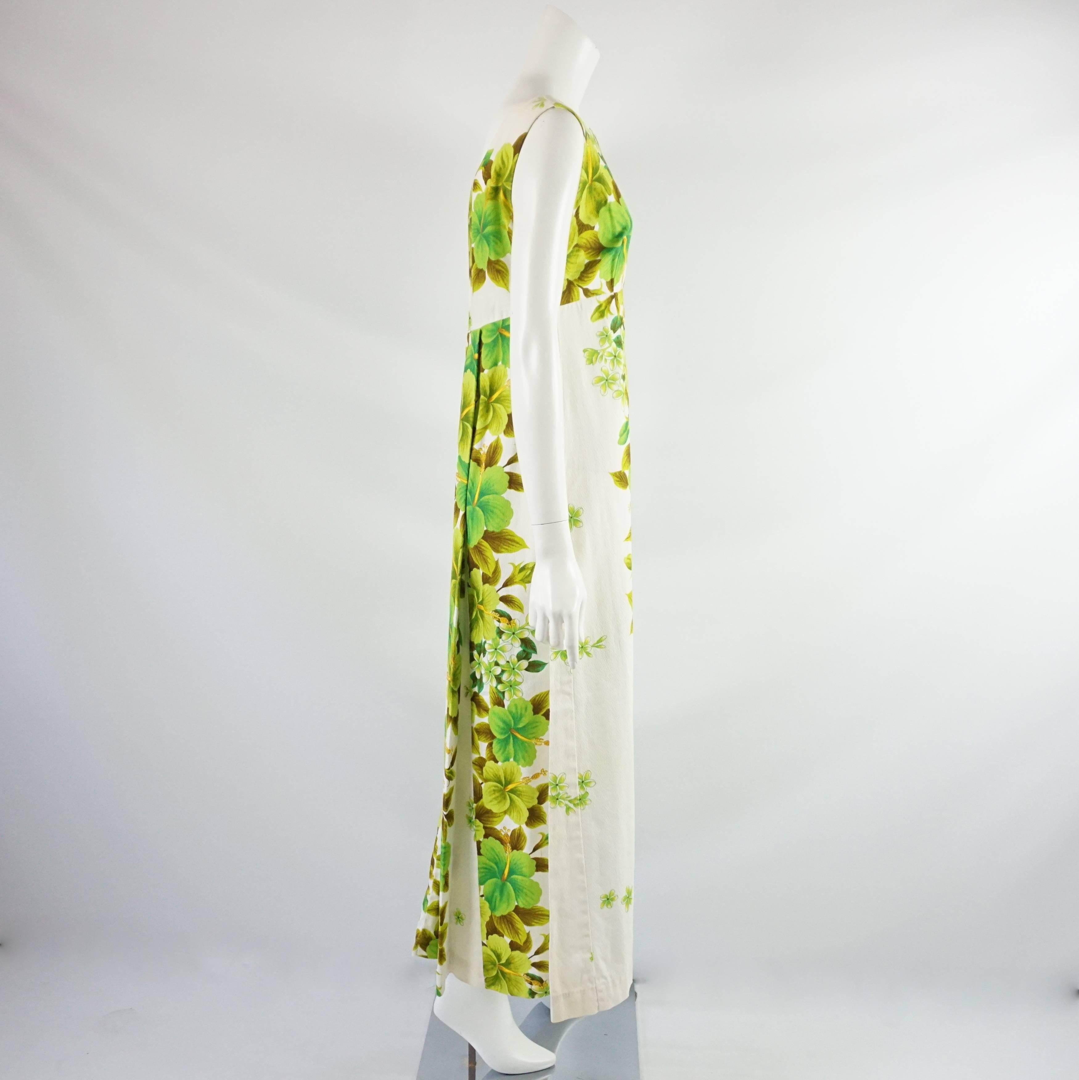 This fun, summer maxi dress made of cotton with a large green Hawaiian flower print. The dress is from Ui Maikai, which is from Hawaii, and is sleeveless. It is in excellent vintage condition with minor wear as seen in the last image. Size 6, circa