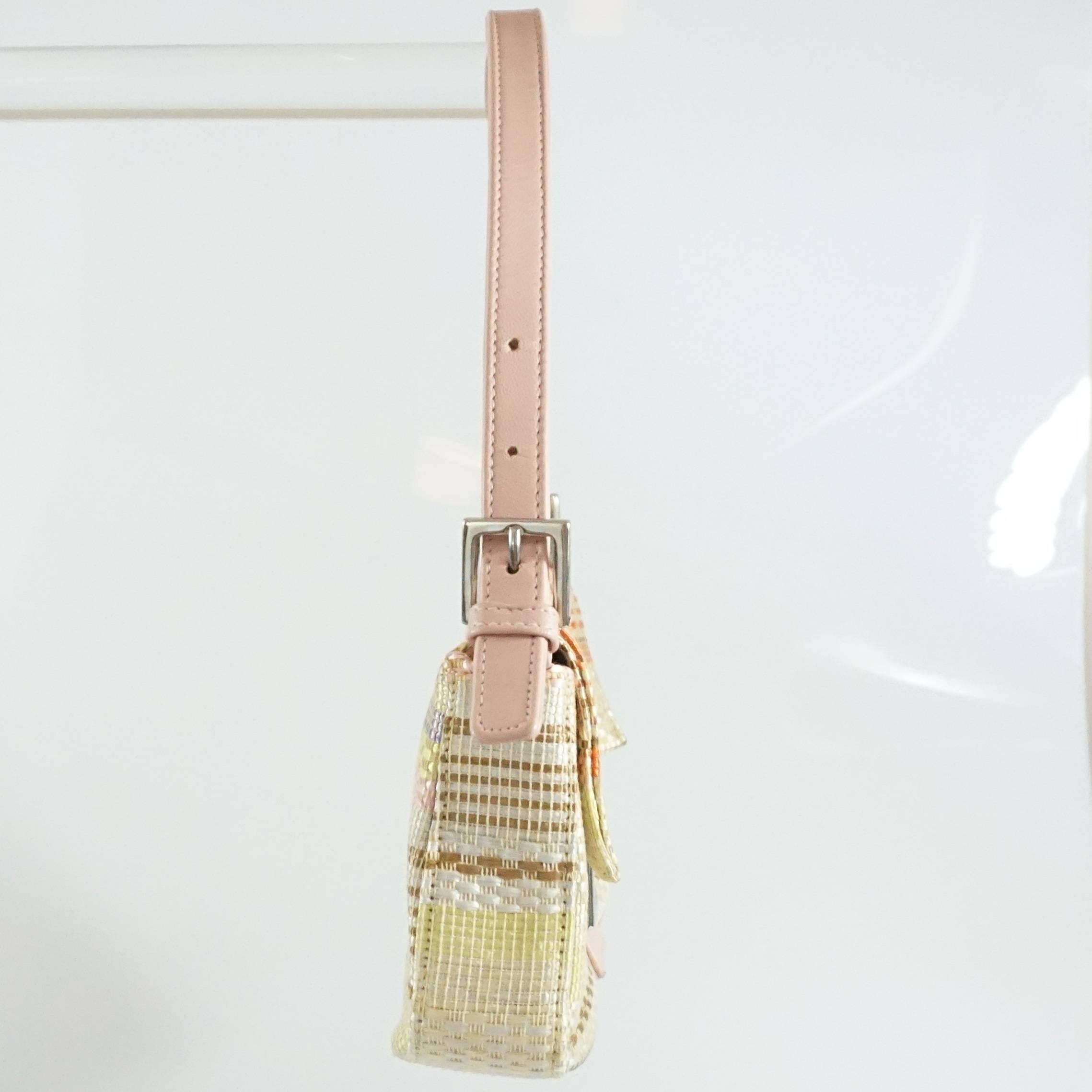 This Fendi handbag is cream with pastel colored stripes. This bag has a woven texture, silver hardware, and a pink handle. This bag is in very good condition with some minor staining on the front buckle leather and inside of the