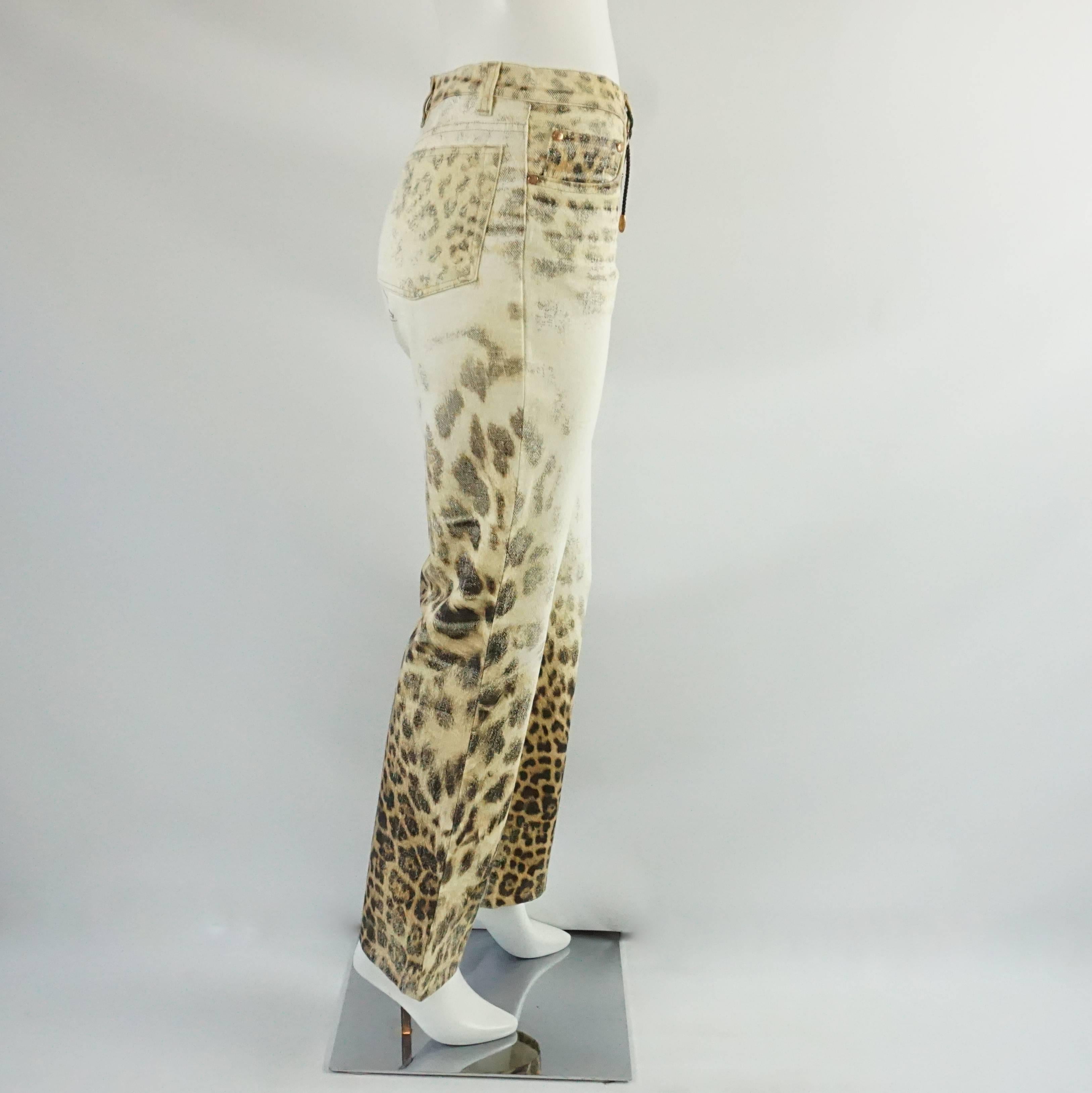 These unique Roberto Cavalli jeans are ivory with a tan and brown animal print on them. They have belt loops and have "Roberto Cavalli" written among the animal print. These jeans are in very good condition with some minor staining. Size