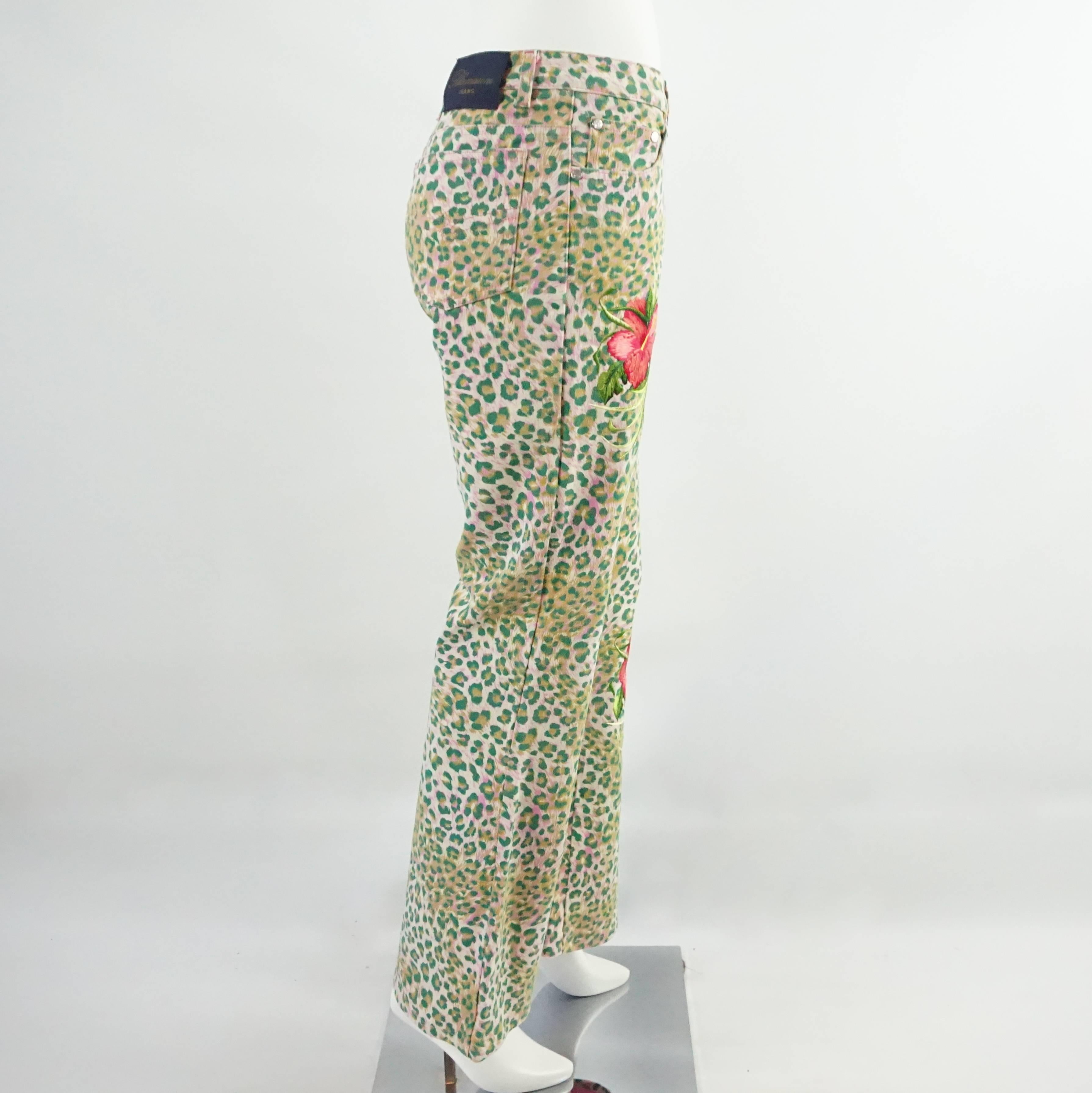 These eye-catching Blumarine jeans are pink and green animal print with flowers embroidered on them. The pant legs flare out slightly. These jeans are in excellent condition with the button somewhat loose. Size 42.

Measurements
Waist: