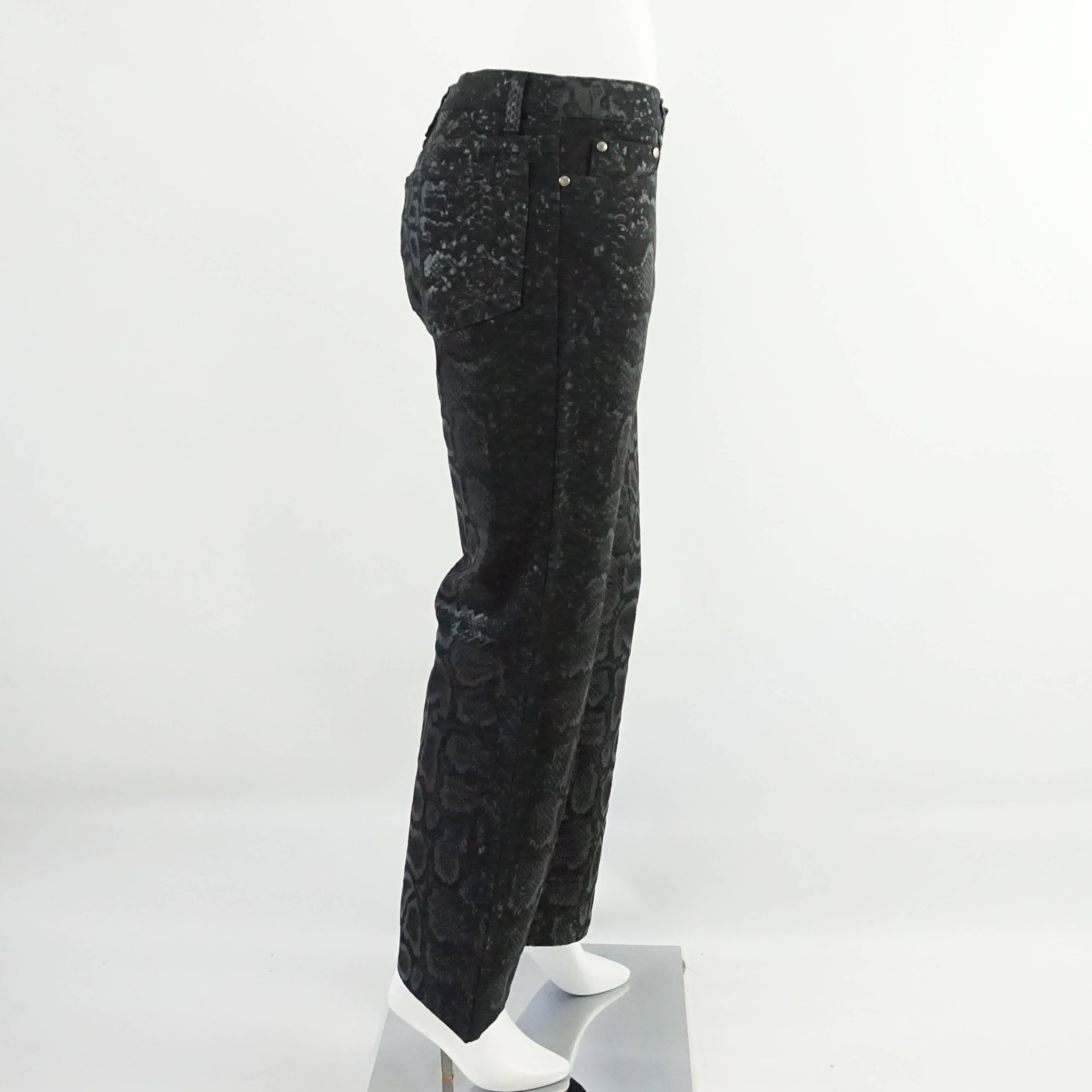 These interesting Roberto Cavalli jeans are black and have a metallic snake print. They are in excellent condition.

Measurements
Waist: 32"
Hips: 36"
Length: 40.25"
Inseam: 31"
Bottom of Pant Leg: 9"