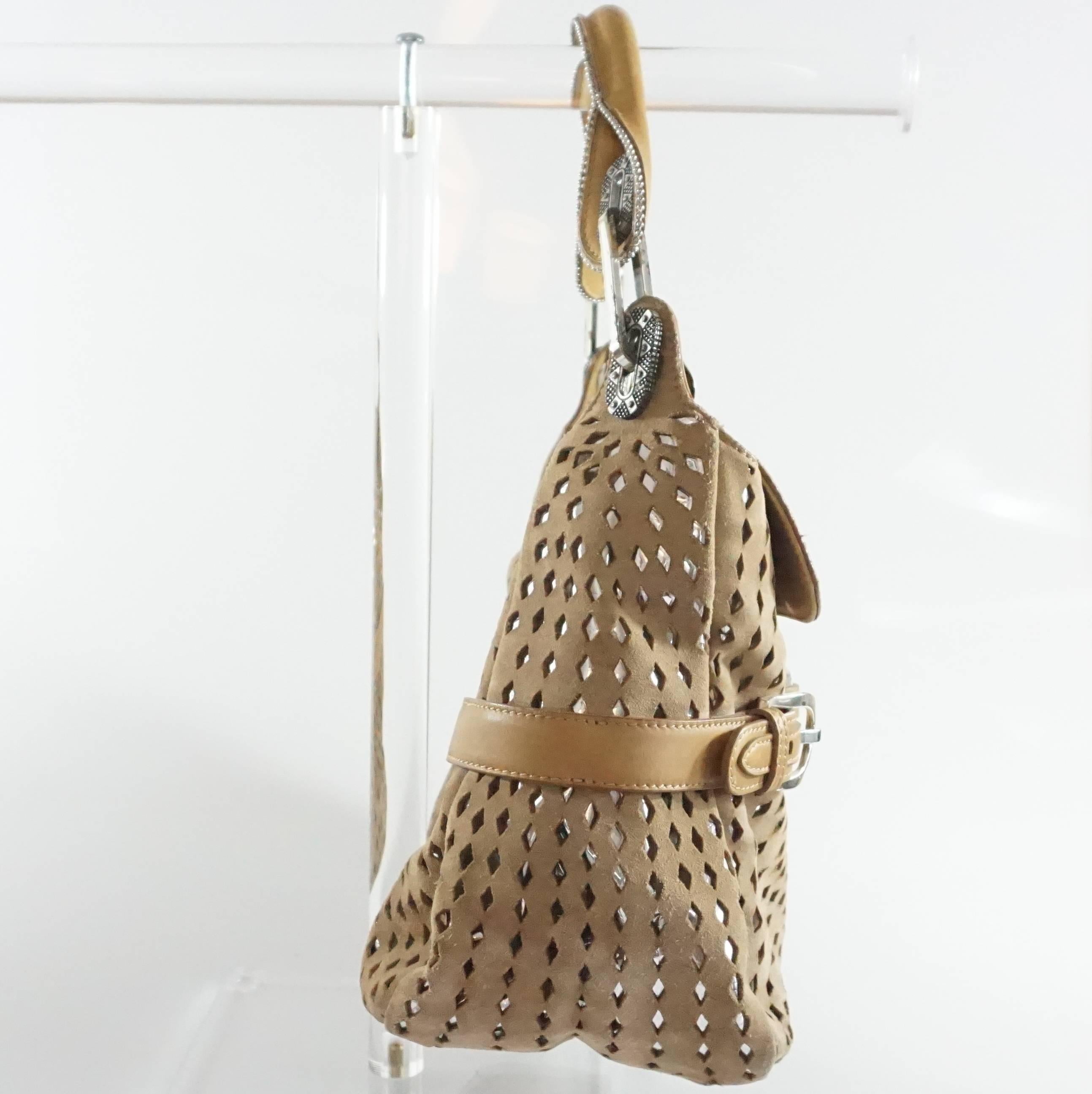 This Jimmy Choo shoulder bag has a bottom silver leather layer with a tan perforated suede layer on top. The bag has silver hardware and a leather shoulder strap. The inside lining is made of cloth and it has 1 zipper compartment and 1 open