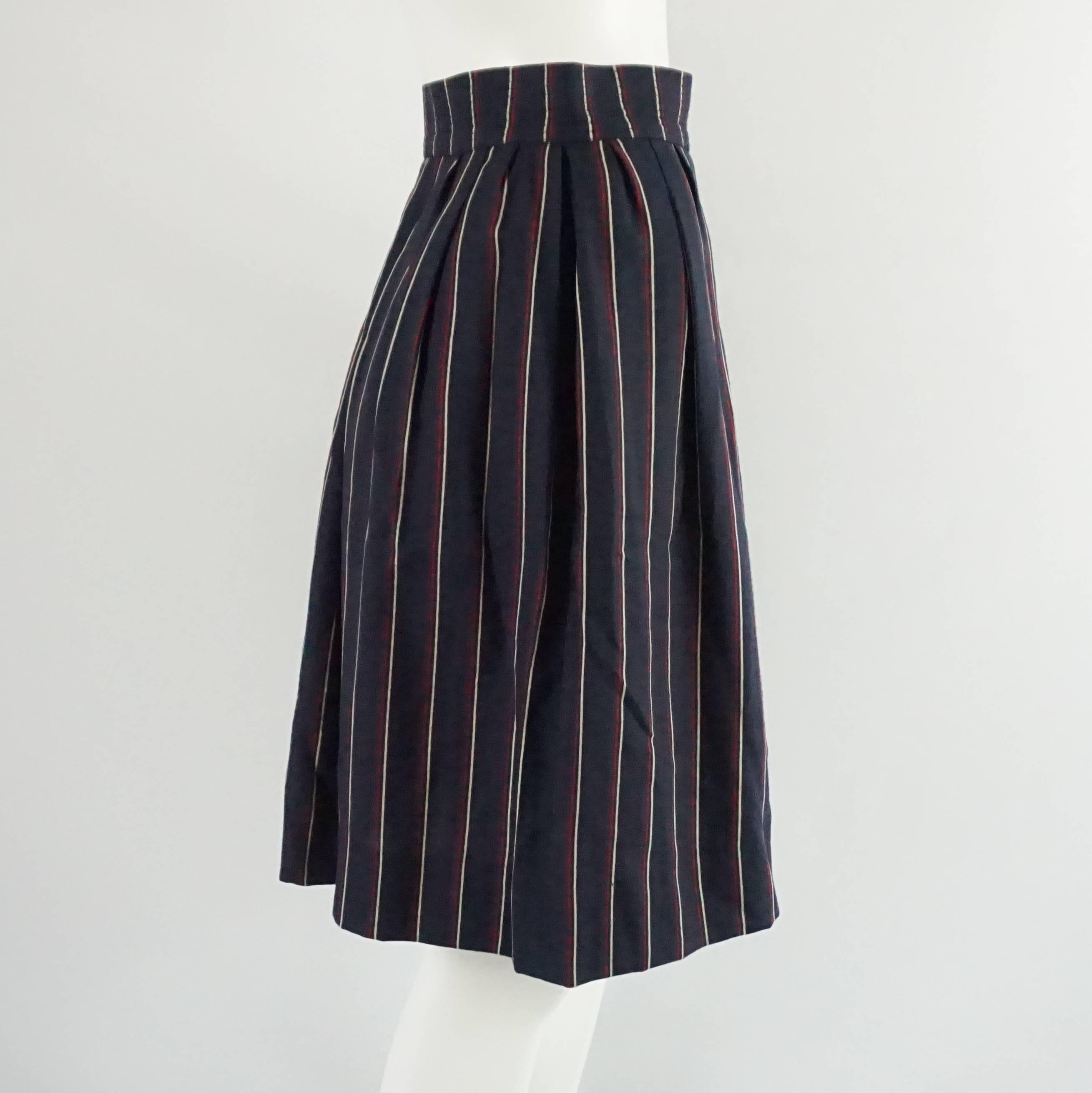 This YSL wool skirt is navy with thin red and white stripes. It is high waisted, has pockets, and falls above the knee. The piece is in excellent vintage condition with minimal wear. Size 36, circa 1960's. 

Measurements
Waist: 25.5