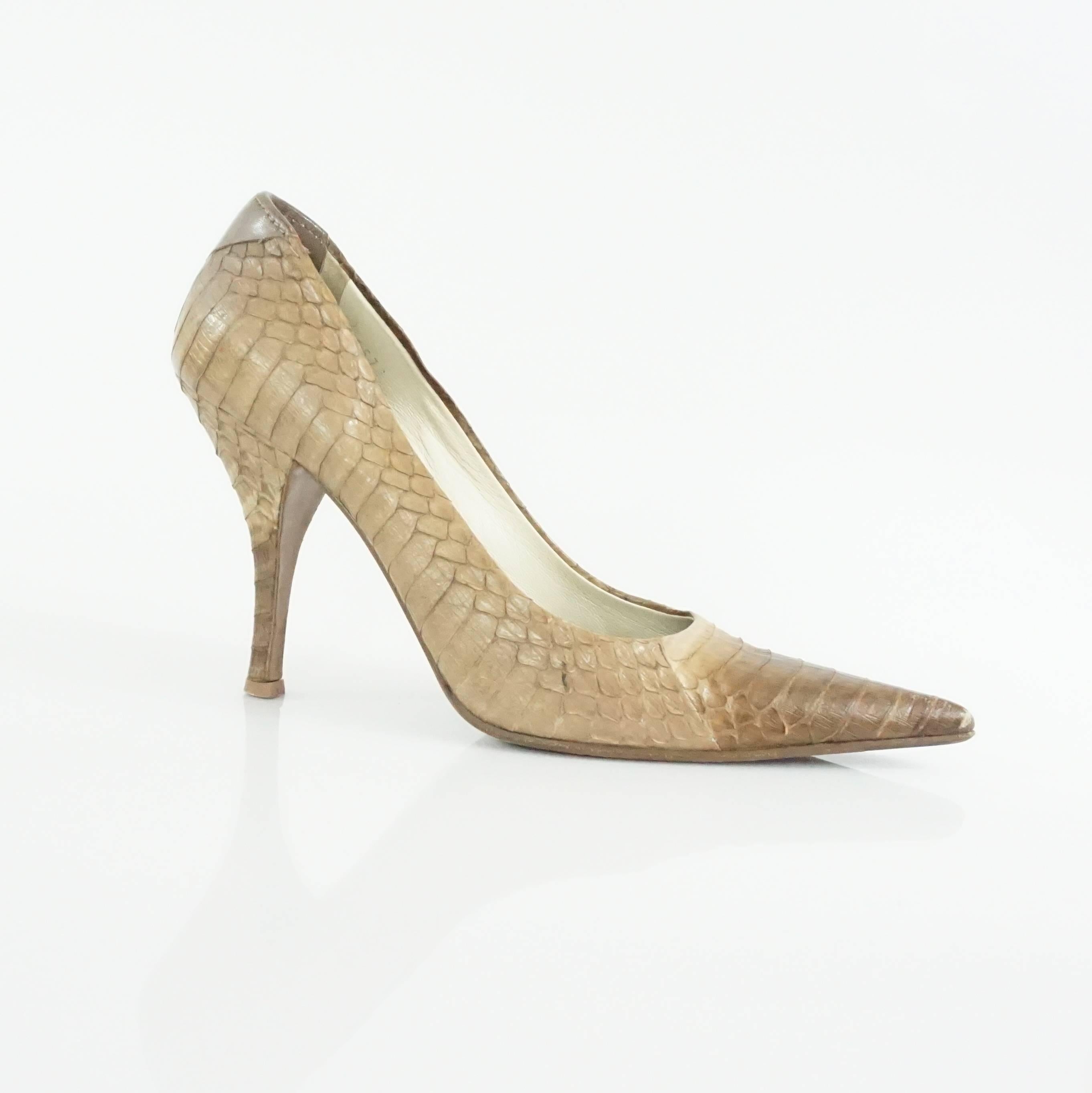 These Prada pumps have a pointed toe. They are beige python and have a heel. These pumps are in very good condition with minor overall wear.

Heel Height: about 4"