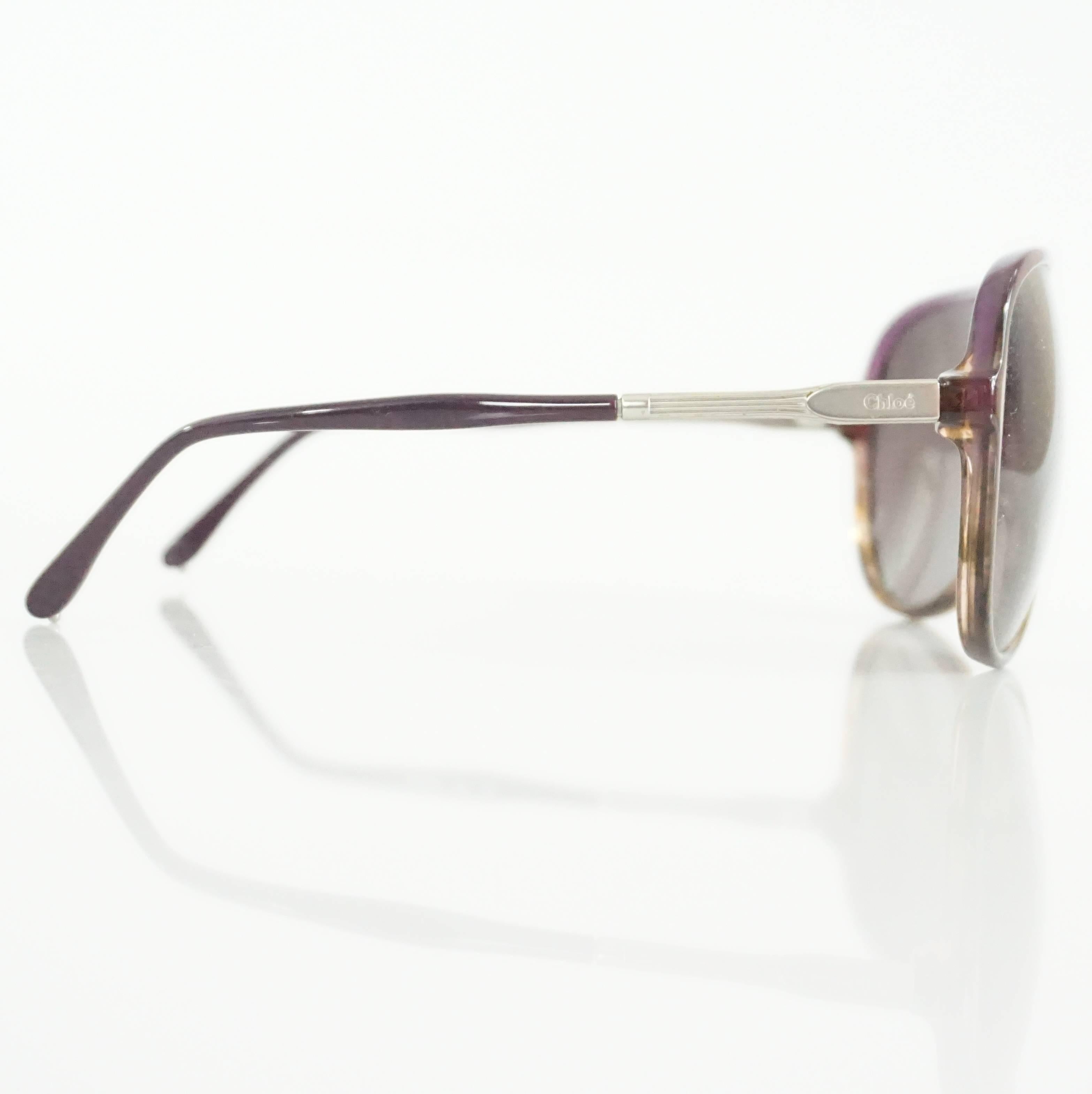 These Chloe sunglasses have brown and purple frames. The lenses are purple and there is silver detailing on the front and legs. These sunglasses are in excellent condition.

Measurements
Front Length: 5.63"
Leg Length: about 5.25"
Length