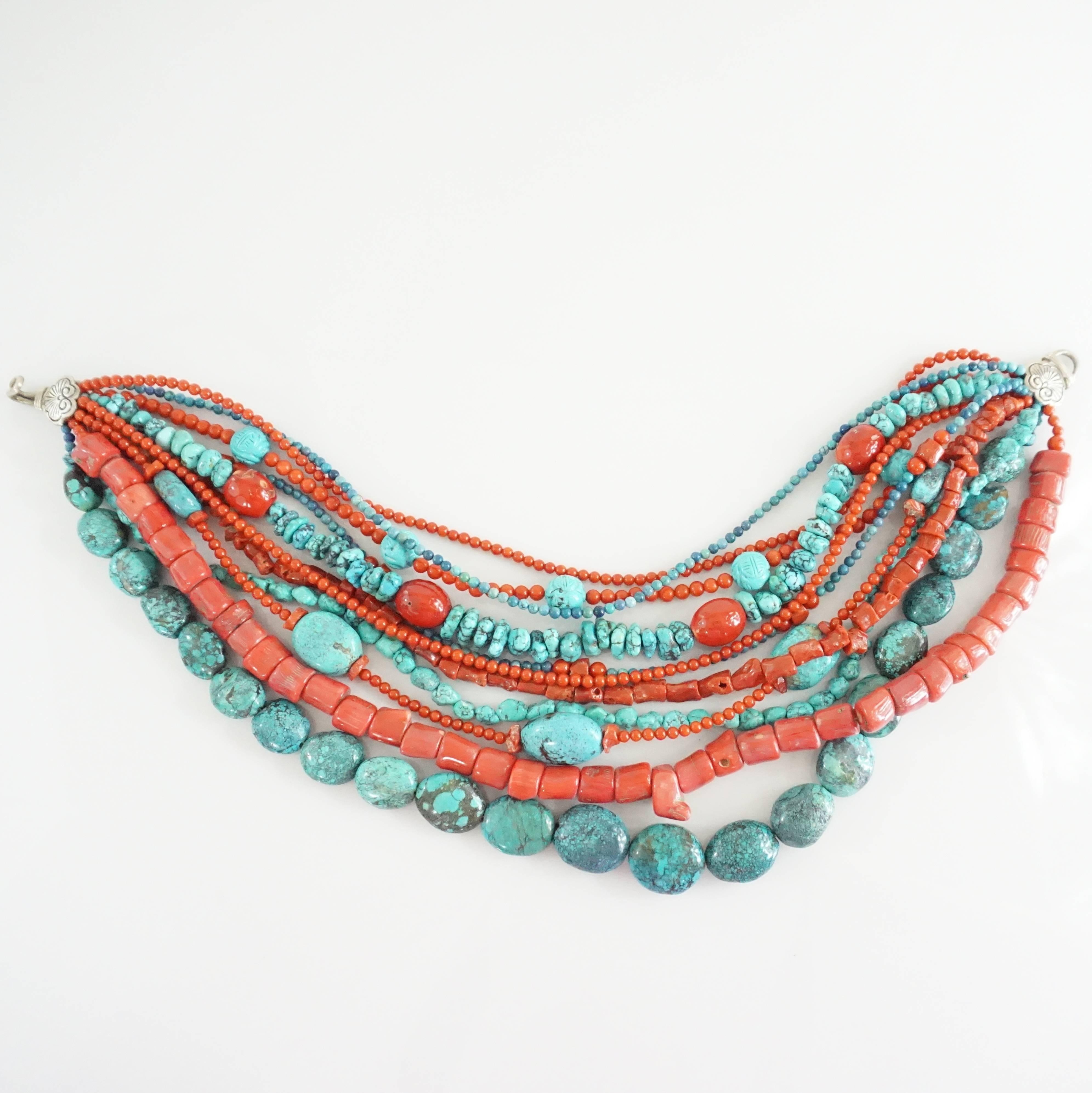 This Stephen Dweck necklace has 11 strands of turquoise and coral. It has a silver closure and different size and shaped beads. This necklace is in excellent condition. 

Measurements
Length: 17"
Width: 2"- 4"