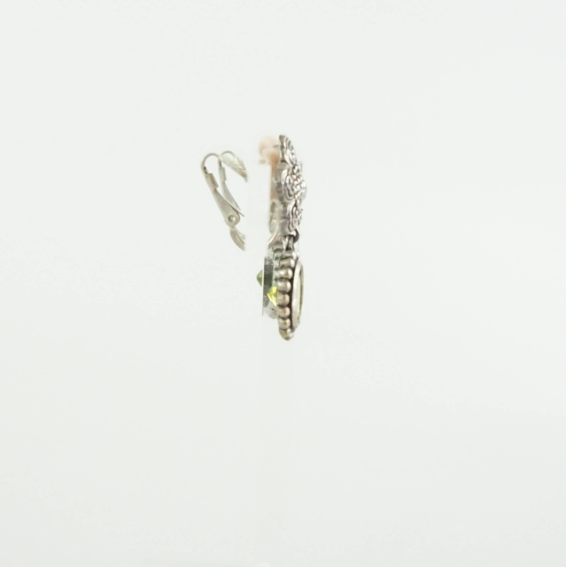 Diese Ohrringe von Stephen Dweck haben einen Peridot-Kristall und eine Blume aus Sterlingsilber. Diese Ohrringe haben einen Clipverschluss und sind gepolstert. Diese Ohrringe sind in ausgezeichnetem Zustand und haben noch ihr Etikett. Seit