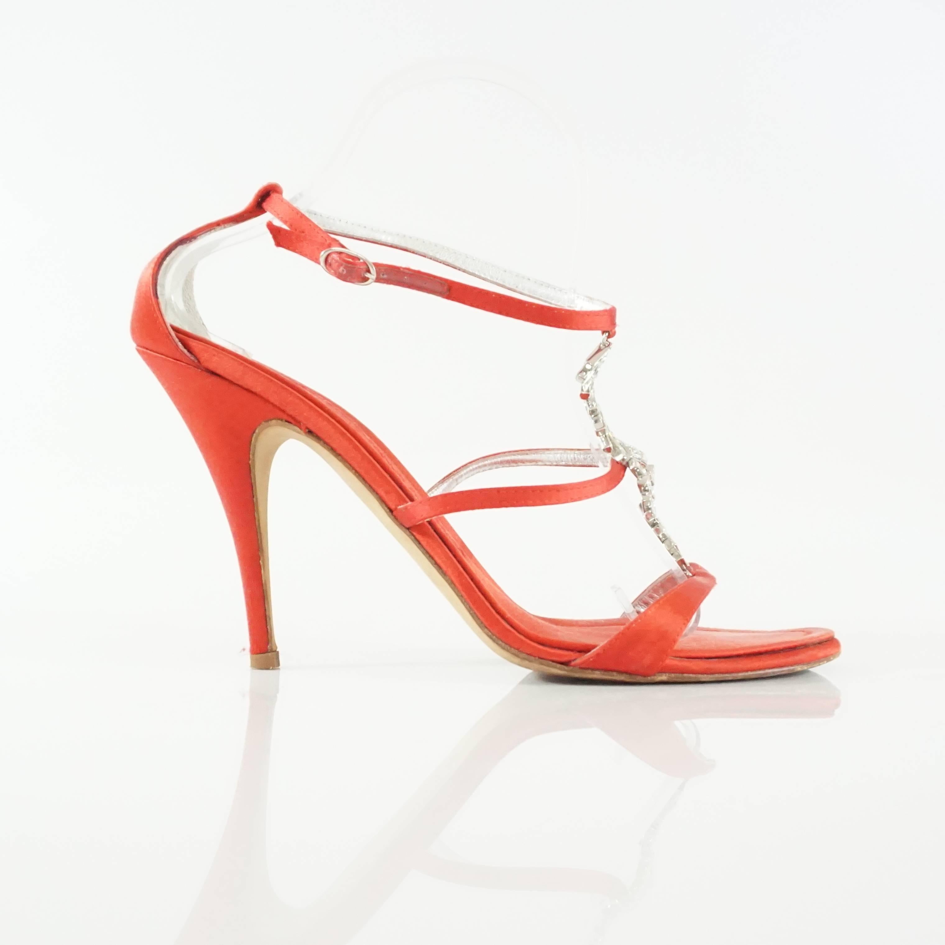 These Giuseppe Zanotti red satin sandals are strappy with a rhinestone strip in the center. The heels also have an ankle strap and small front platform. They are in excellent condition with minimal wear on the bottom and toe bed. Size 40.
