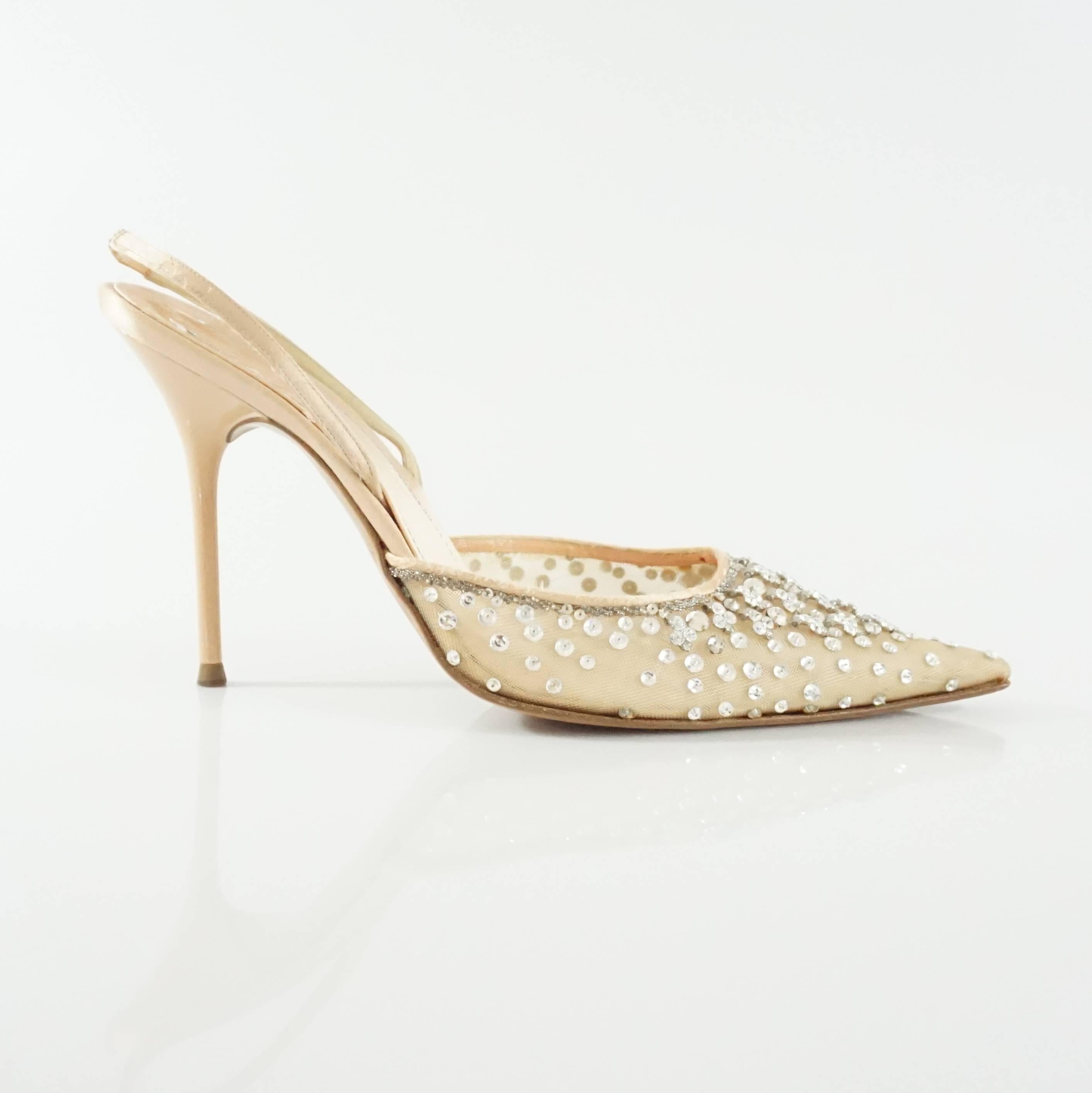These nude mesh slingback heels are encrusted with different shape rhinestones. The heels are in good condition with some wear on the mesh, stones, and bottom as indicated in the images. 

Measurements
Heel: 4.25"