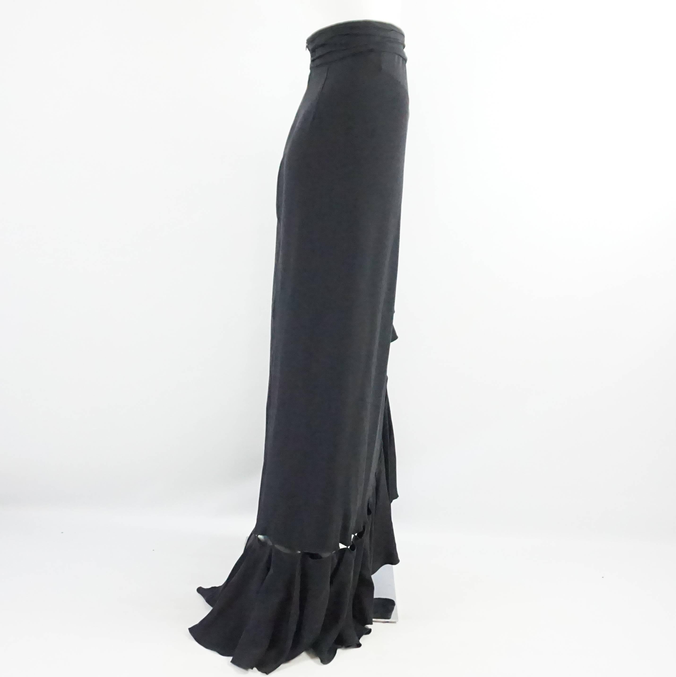 This Naeem Khan black silk maxi skirt has large ruffles along the front and bottom. The bottom also has a cutout detail just above the ruffle. The skirt is in excellent condition with minimal wear. Size 12. 

Measurements
Waist: 31"
Hips: