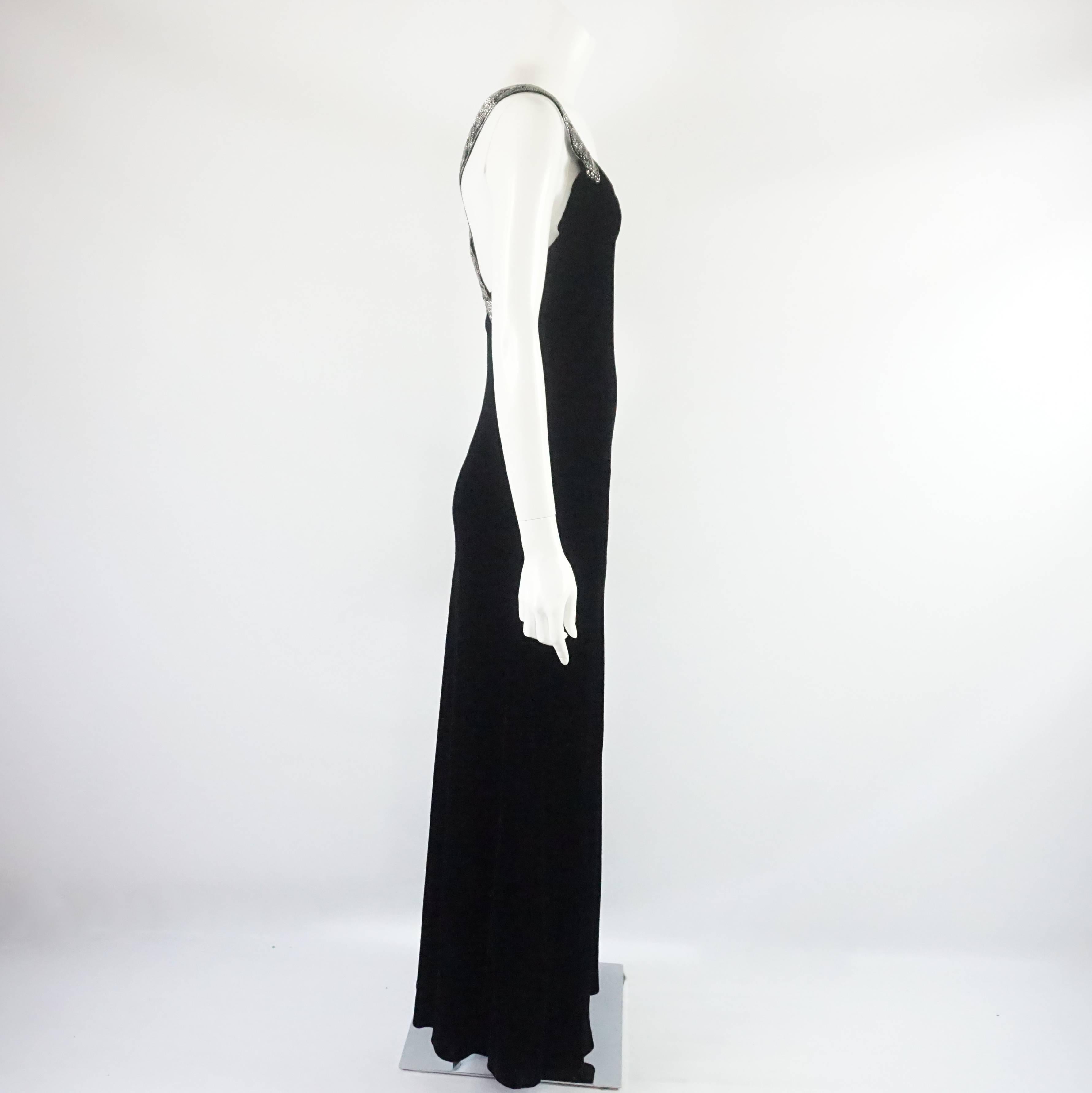 This stunning Ralph Lauren gown is black velvet. It has rhinestone and beaded straps that cross elegantly in the back. The dress is fitted and is in excellent vintage condition with minimal wear. Size 8, circa 1990’s. 

Measurements
Bust: