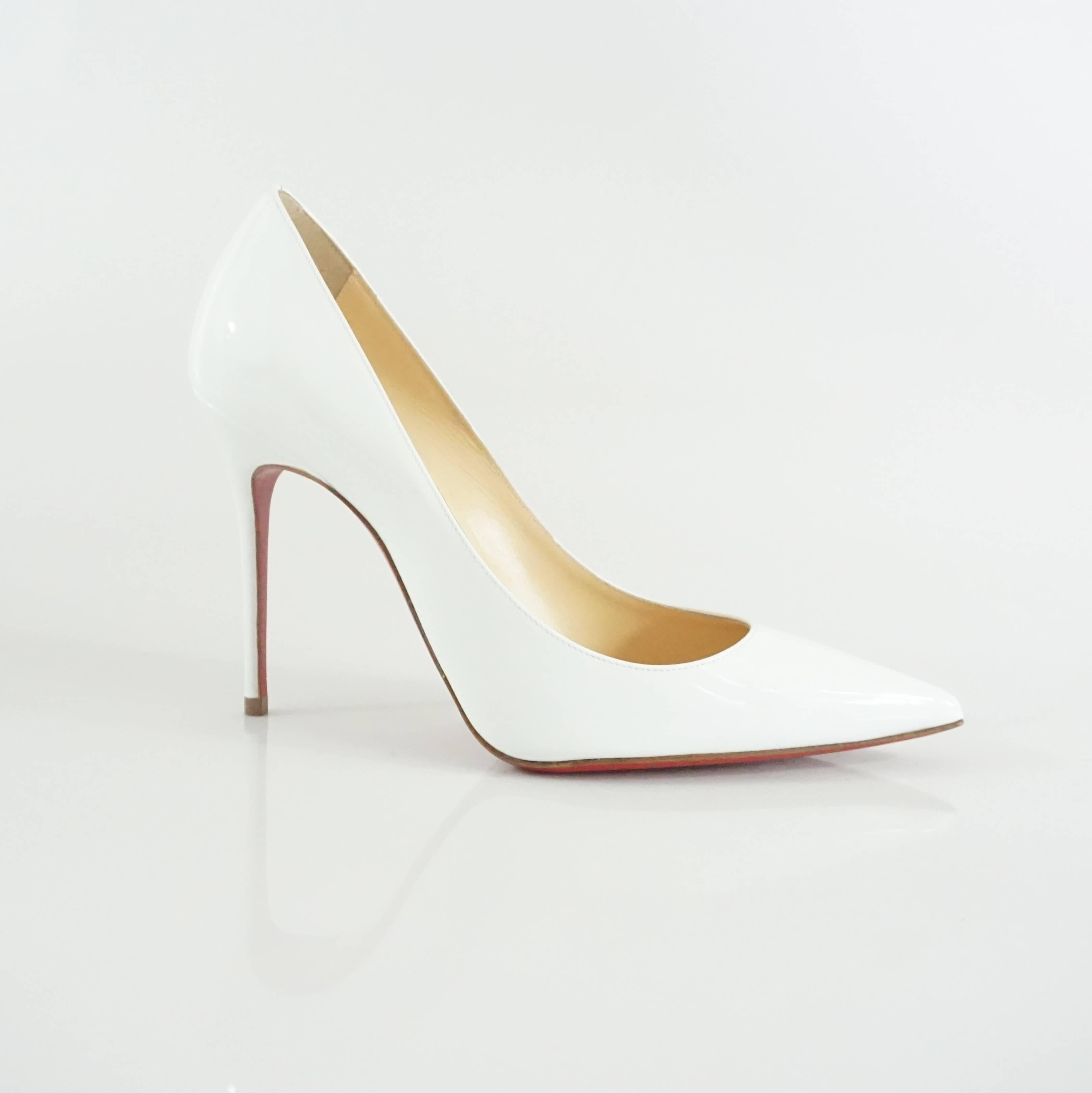 These Louboutin white patent pumps are  new and come with the original box and dusters. They are a sleek pointed toe style and perfect for any outfit. The heels are in excellent condition with a very small section with a scuff in the front of the