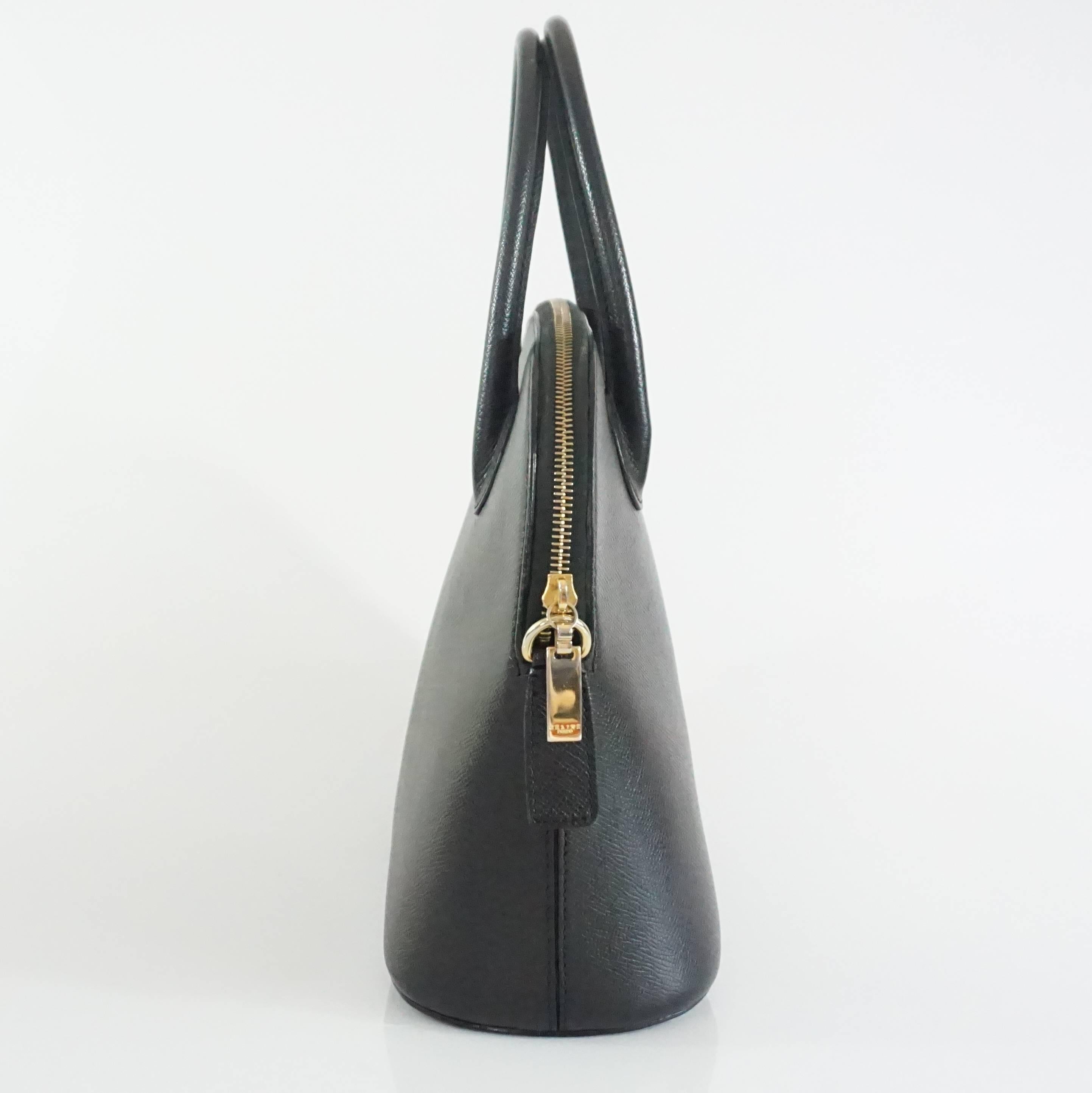 This beautiful Celine bag features black saffiano leather, top handles, and a removable shoulder strap. There is a zippered interior pocket and 4 feet. This bag is in very good condition with some markings on the leather.

Measurements
Height: