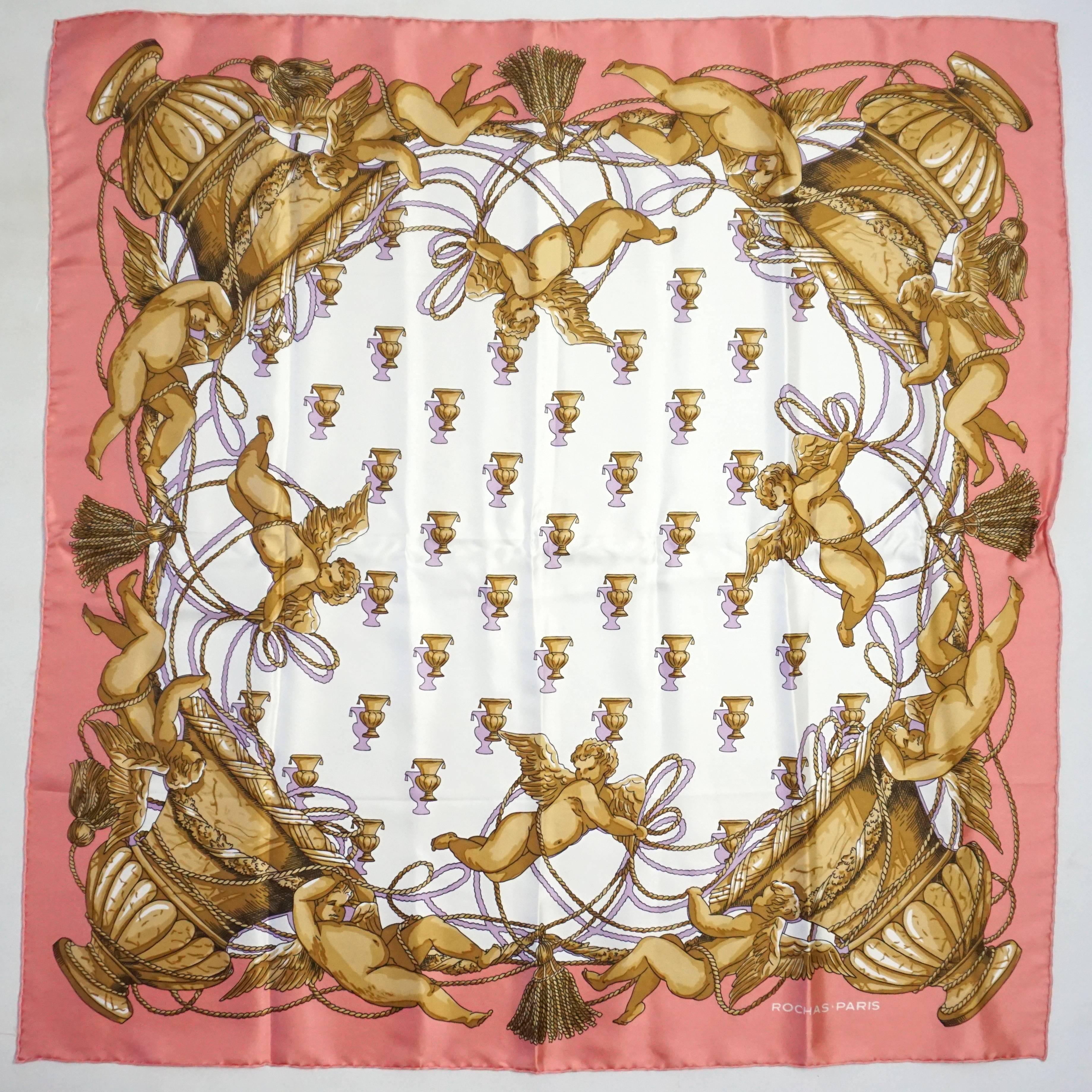 This Rochas silk scarf is a mixture of pink, ivory, gold, and lavender colors. The scarf has a regal cherub print on it and is in excellent condition with minimal wear and one small pull. 

Measurements
Height: 35.25