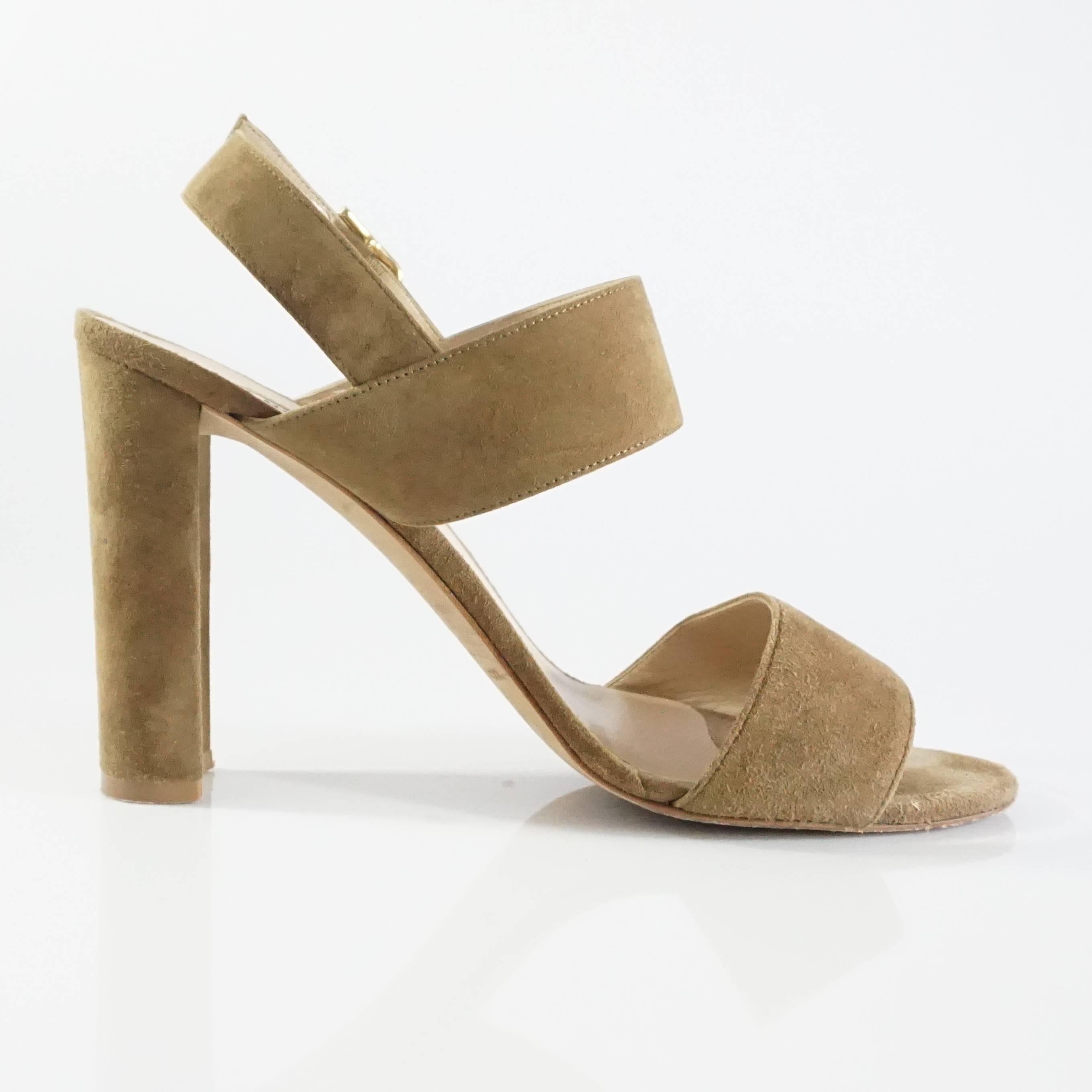 These Manolo Blahnik Khans sandals are taupe suede. They feature a strap over the toes, over the foot, and around the ankle. These shoes are in fair condition with marks in the toe bed, on the toe strap, and wear to the suede on the heels. Size
