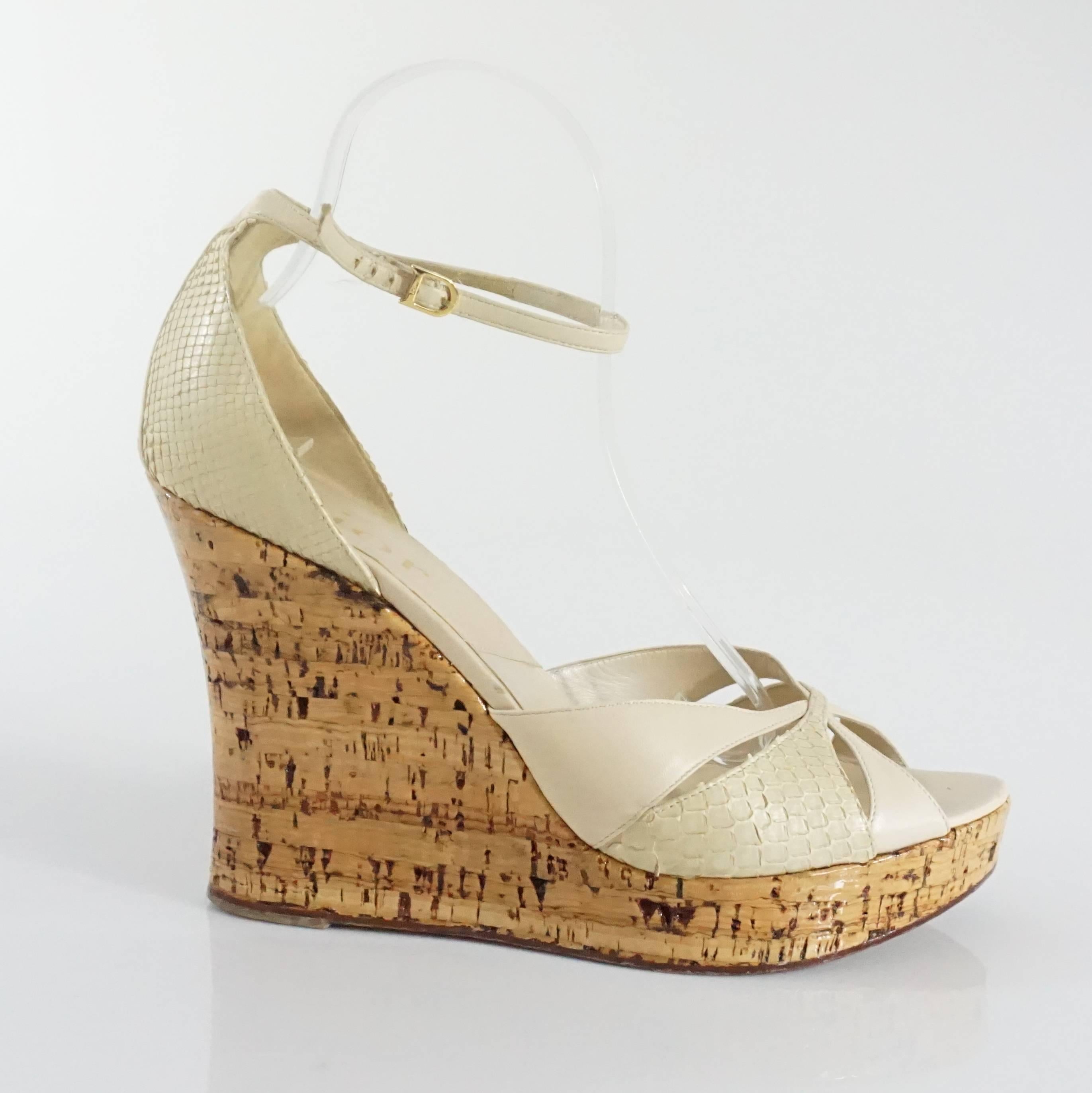 These Christian Dior cork wedges have beige straps. One of the straps have a snakeskin texture. The wedge is made to have a cork appearance. These wedges are in good condition with some scuffing. Size 42.

Wedge Height: 4.88"
Platform: