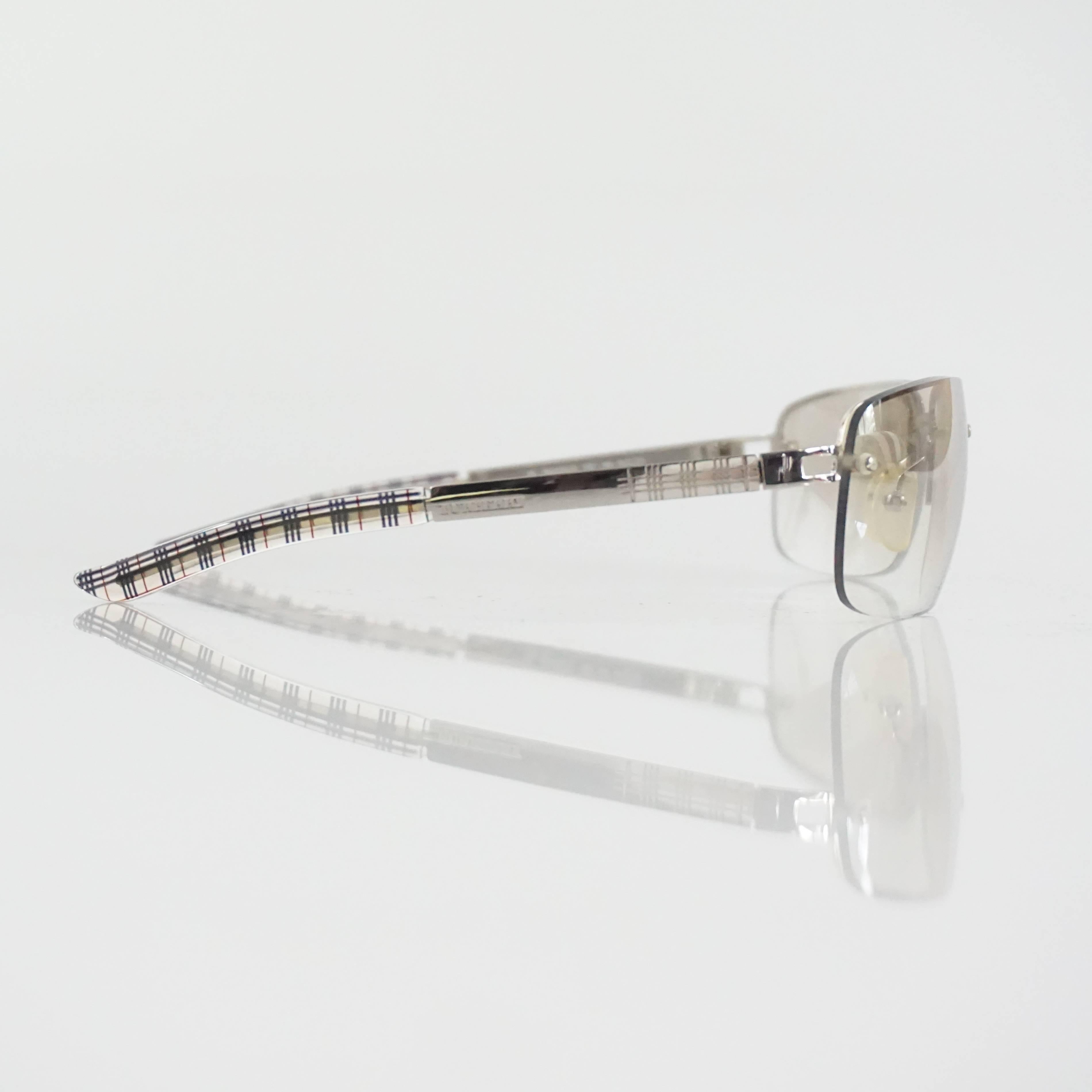 These Burberry sunglasses have small silver lenses. The legs are silver and the iconic Burberry print. They are in good condition with overall wear and comes with a case.

Measurements
Front Length: 5.13"
Leg Length: about 4.75"
Height of