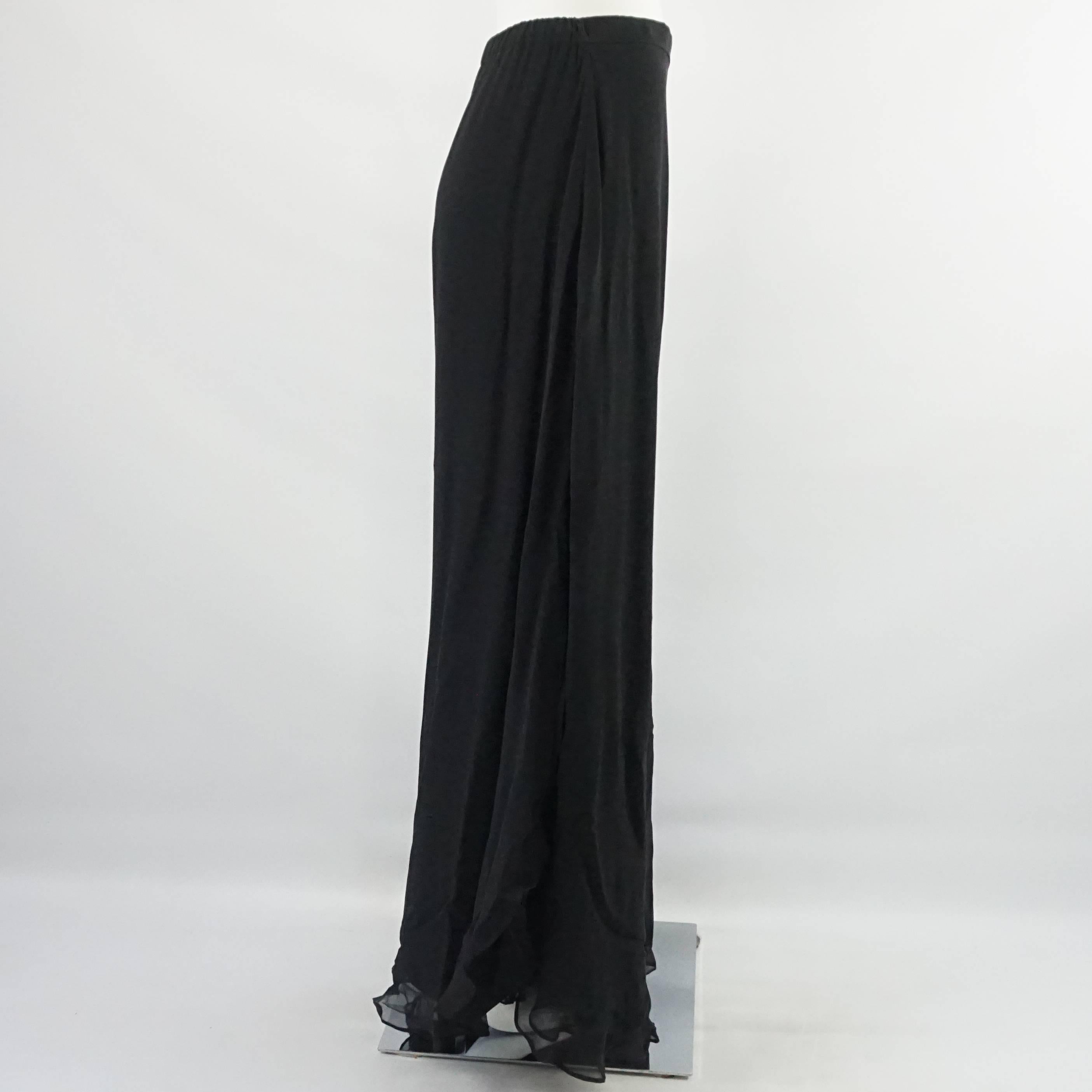 These St. John Evening pants are black and with layers of silk chiffon. They have asymmetrically cut palazzo pant legs with slits. These pants are in excellent condition.

Measurements
Waist: 28"
Hips: 39"
Length: 46"
Inseam: 32"