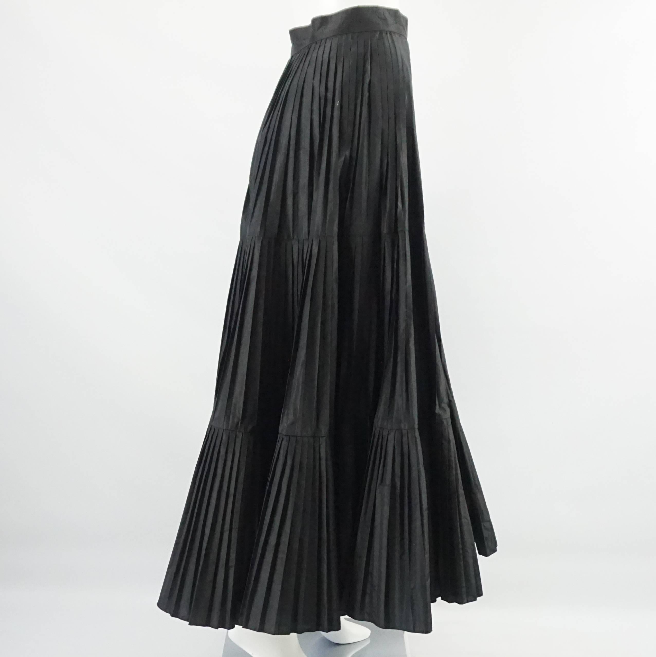 Serge & Real Black Taffeta Pleated Long Skirt - M. This Serge & Real long skirt is black taffeta. It is pleated and loose. This skirt is in good condition with minor marks and a sticky residue on it- needing dry cleaning. Size