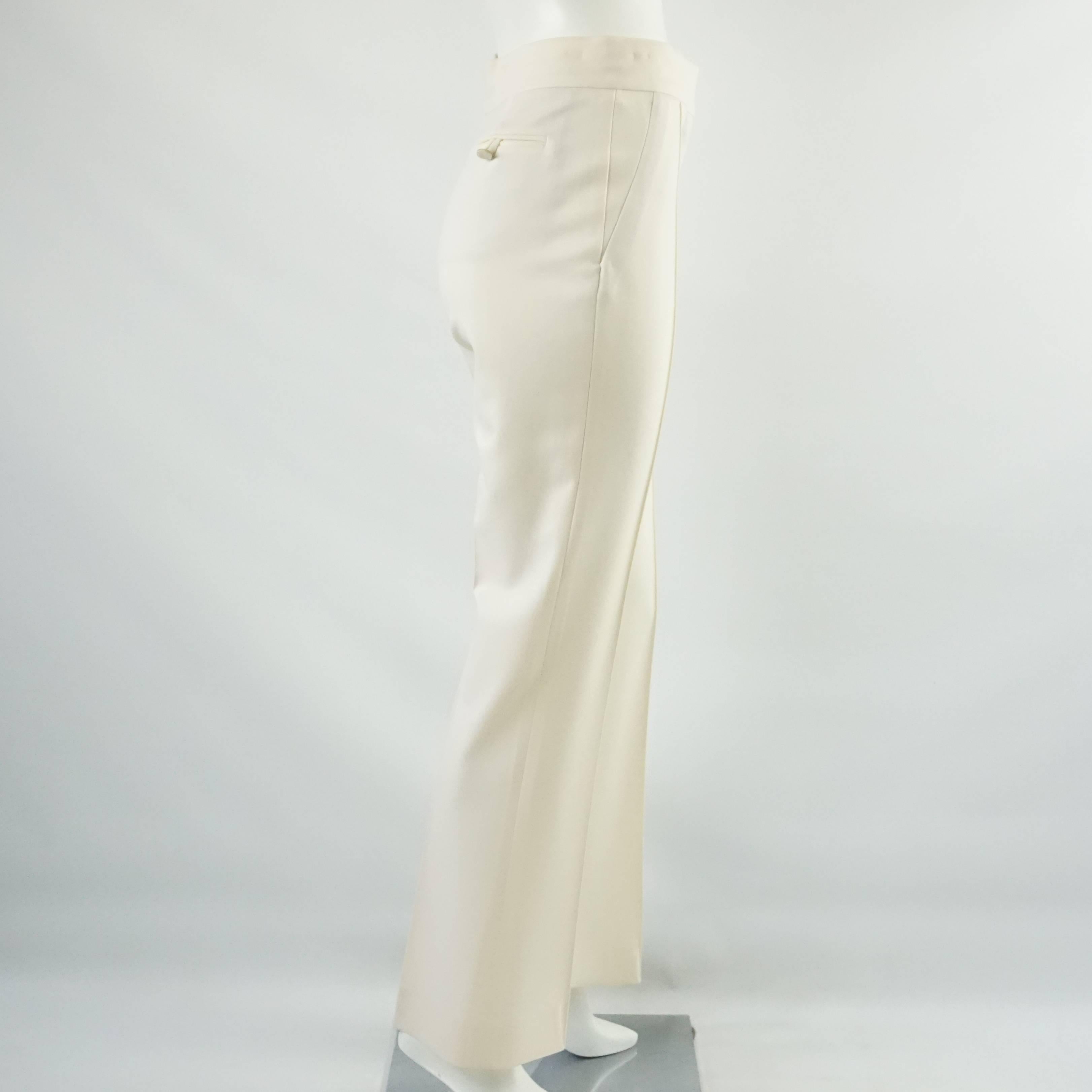 Valentino Ivory Wool Wide Leg Pants - 4. These beautiful Valentino pants are ivory wool. They feature a wide leg and a pleat down the front of each leg. These pants are in good condition with some staining. Size 4.

Measurements
Waist: 28