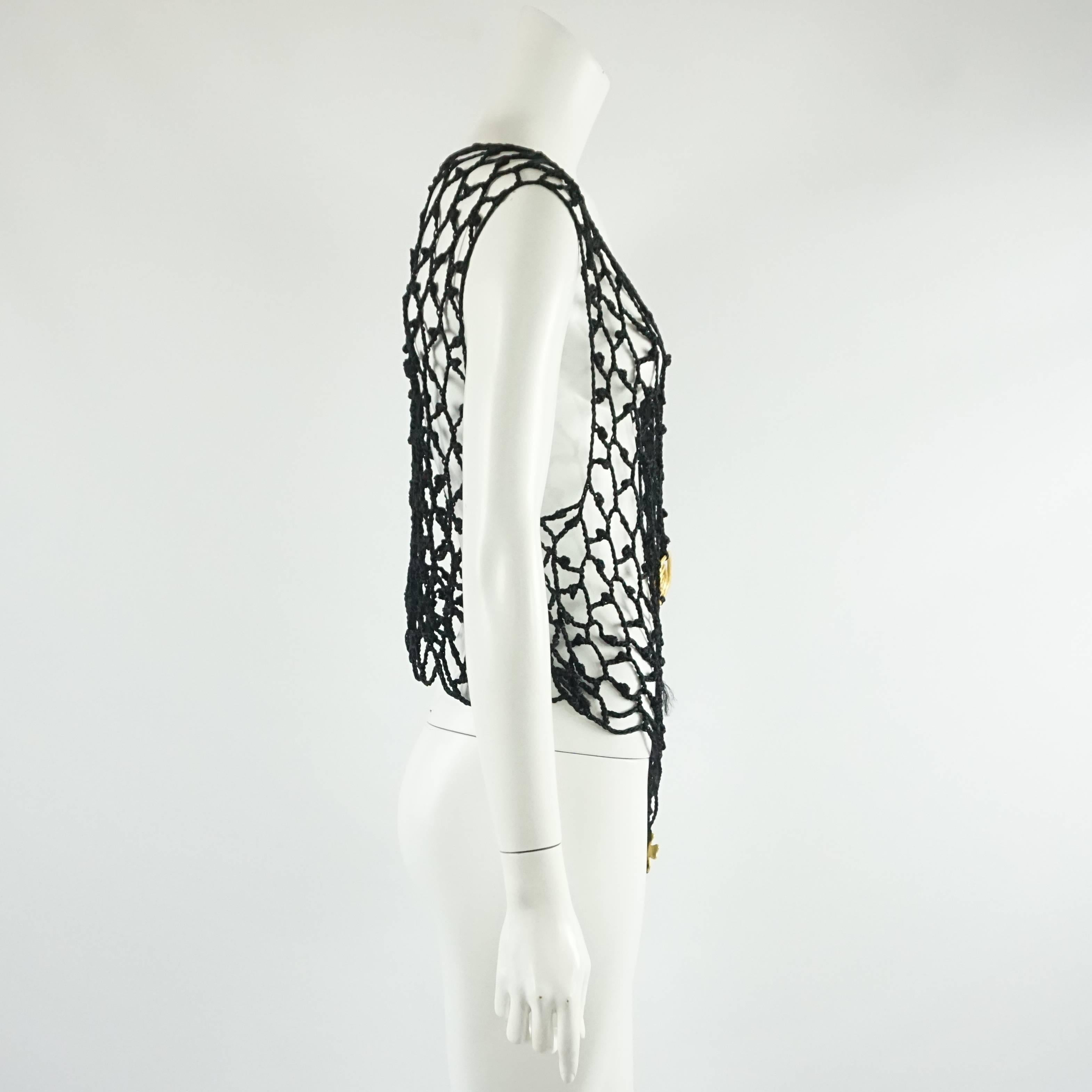This highly collectible vintage Christian Lacroix black open crochet blouse is loose fitting with 4 large, hammered gold buttons in the front. The blouse hangs asymmetrically with a longer portion in the front and fits various sizes. Size M, circa