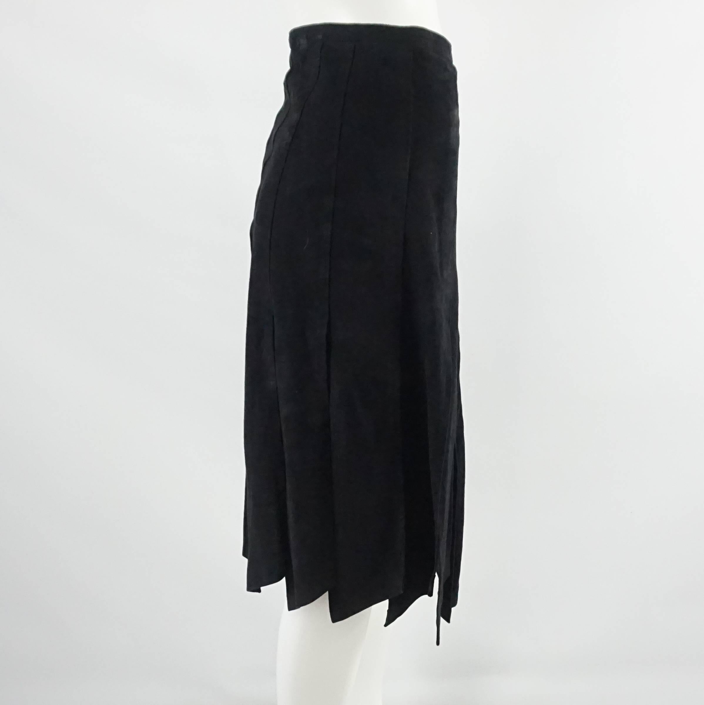 This vintage black suede car wash pleat skirt is a striking piece. It has slits running up to the upper thigh and a back zipper. The piece is in fair vintage condition with some general wear to the fabric. Size M, circa 1990's.