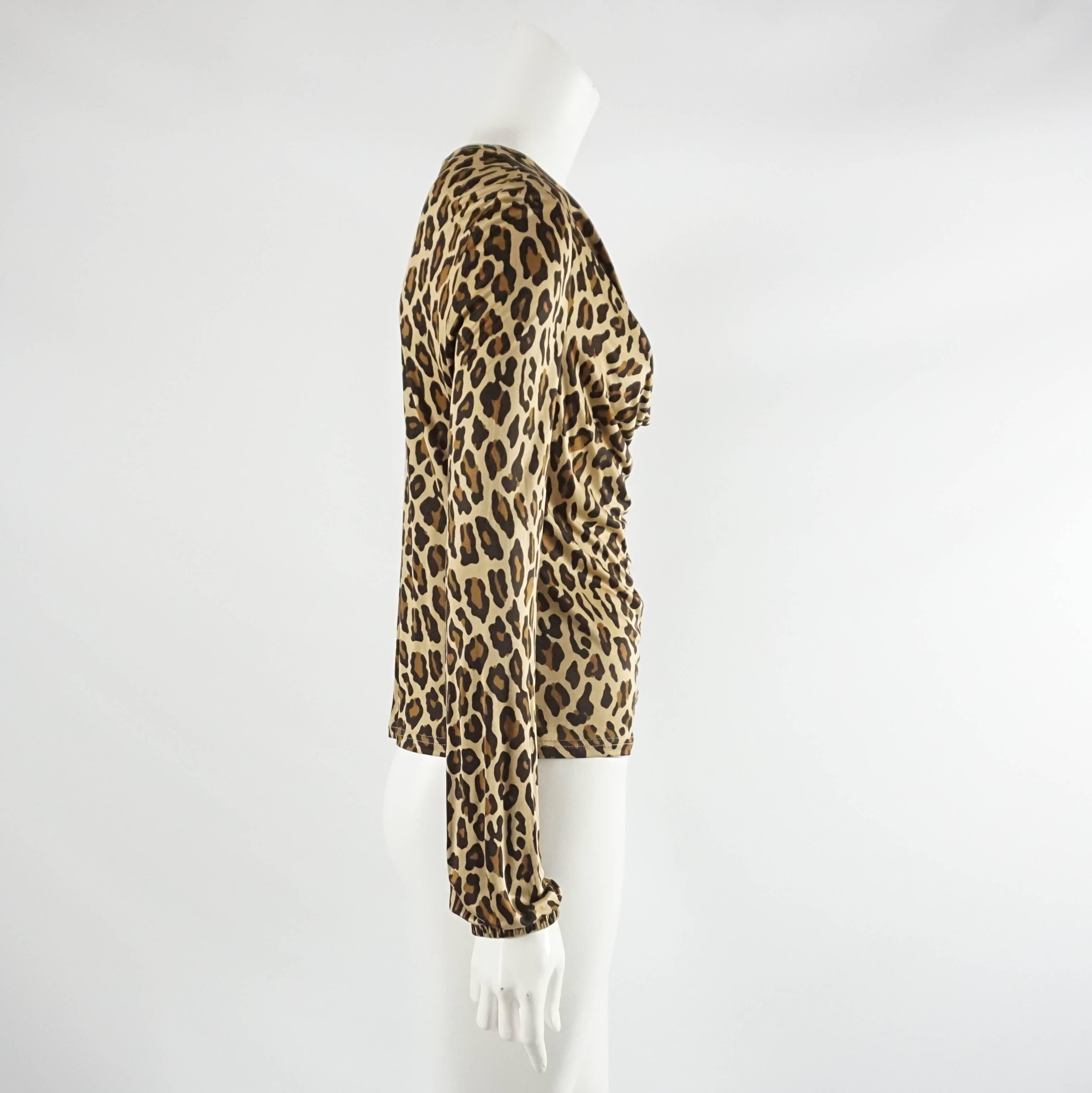 This Celine animal print long sleeve blouse is made of jersey and has a swoop neck. The piece is in fair condition with several small areas of discoloration and small pulls as seen in the images. Size S, circa 21st century. 

Measurements
Shoulder