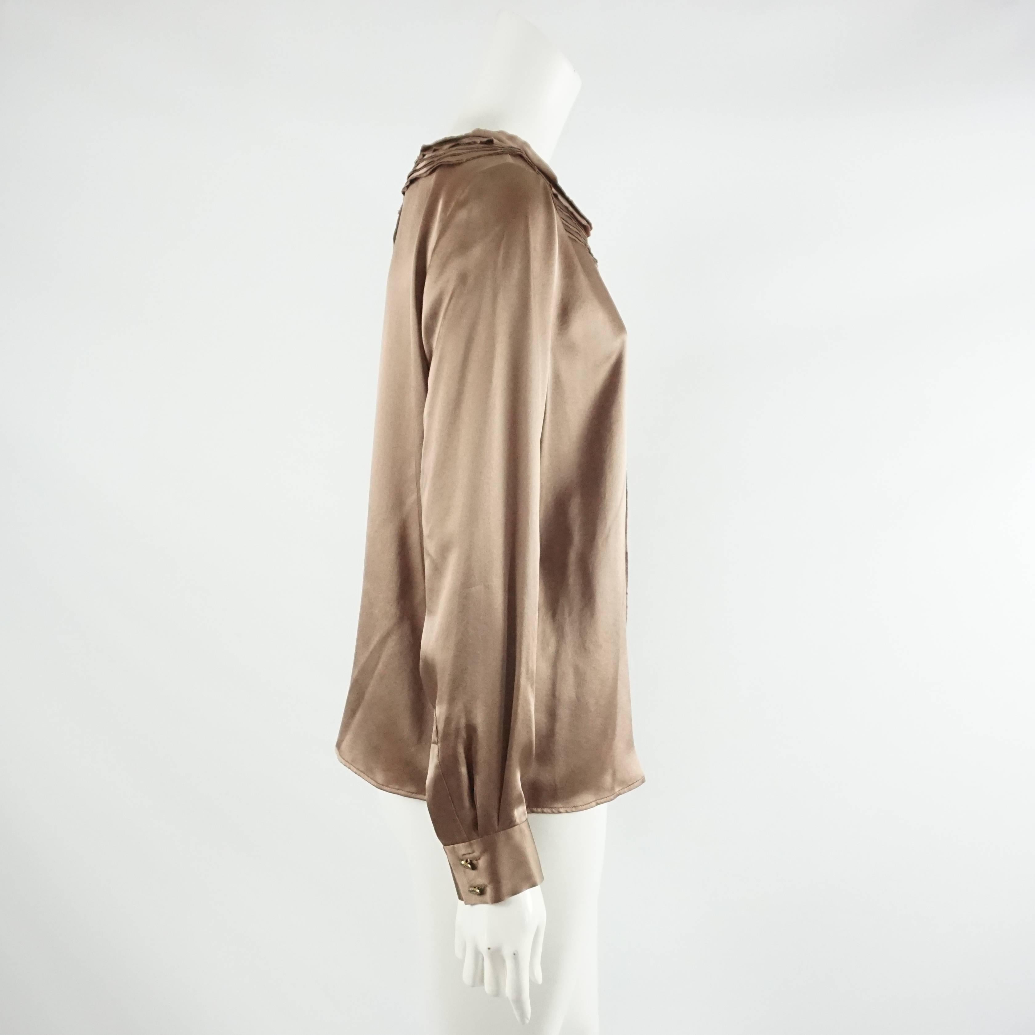 Oscar de la Renta Brown Silk Top-10 NWT. This gorgeous top is made of silk and is a milk chocolate brown color. The top is long sleeved with cuffed ends and has a soft neckline. There is trim detail going down the front as well as around the