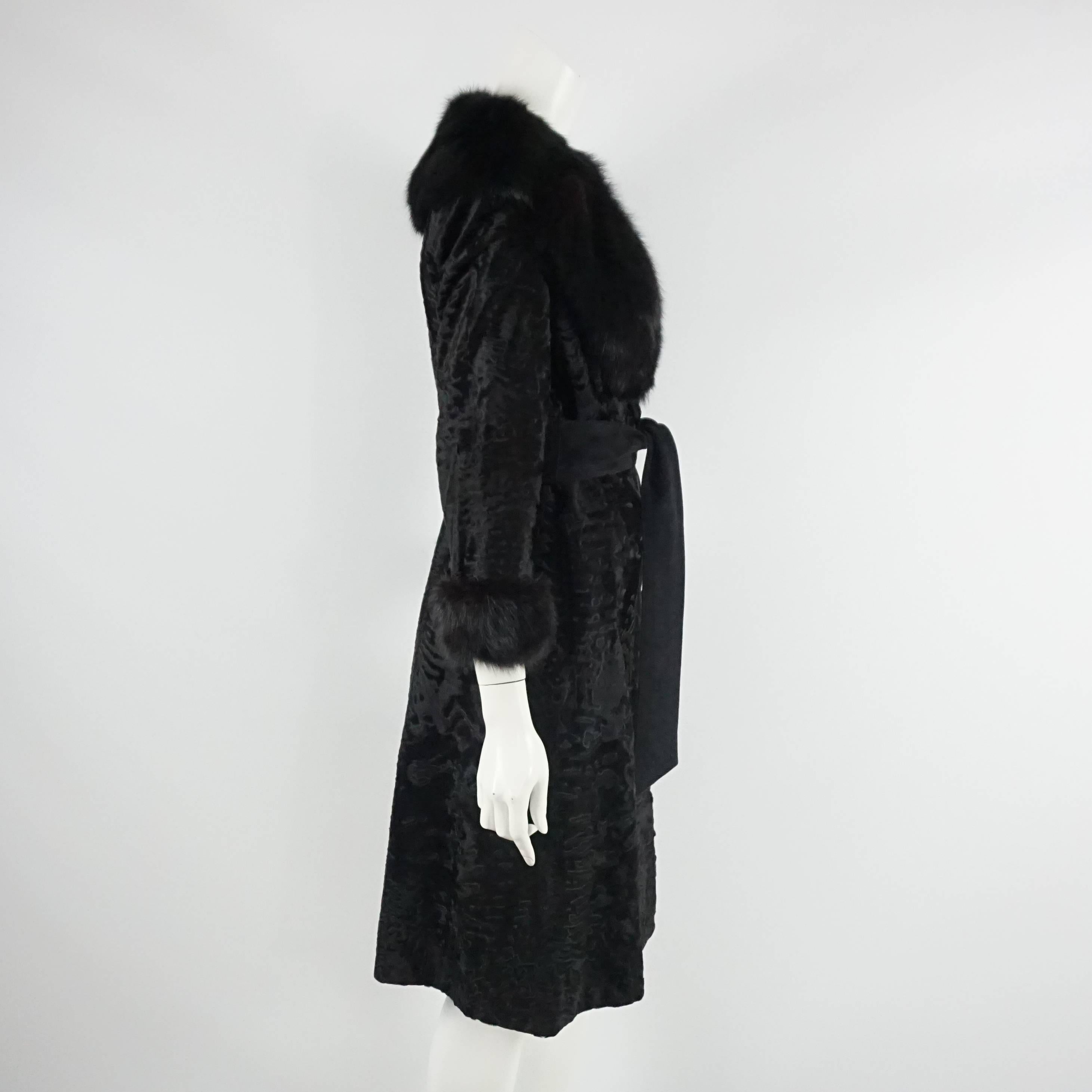Birger Christensen Black Broadtail Coat with Large Fox Collar - M - Circa 90's This spectacular black broadtail coat 3/4 coat has a striking fox collar and cuffs. It has two hook an eye closures at the chest and waist (crosses over slightly), side