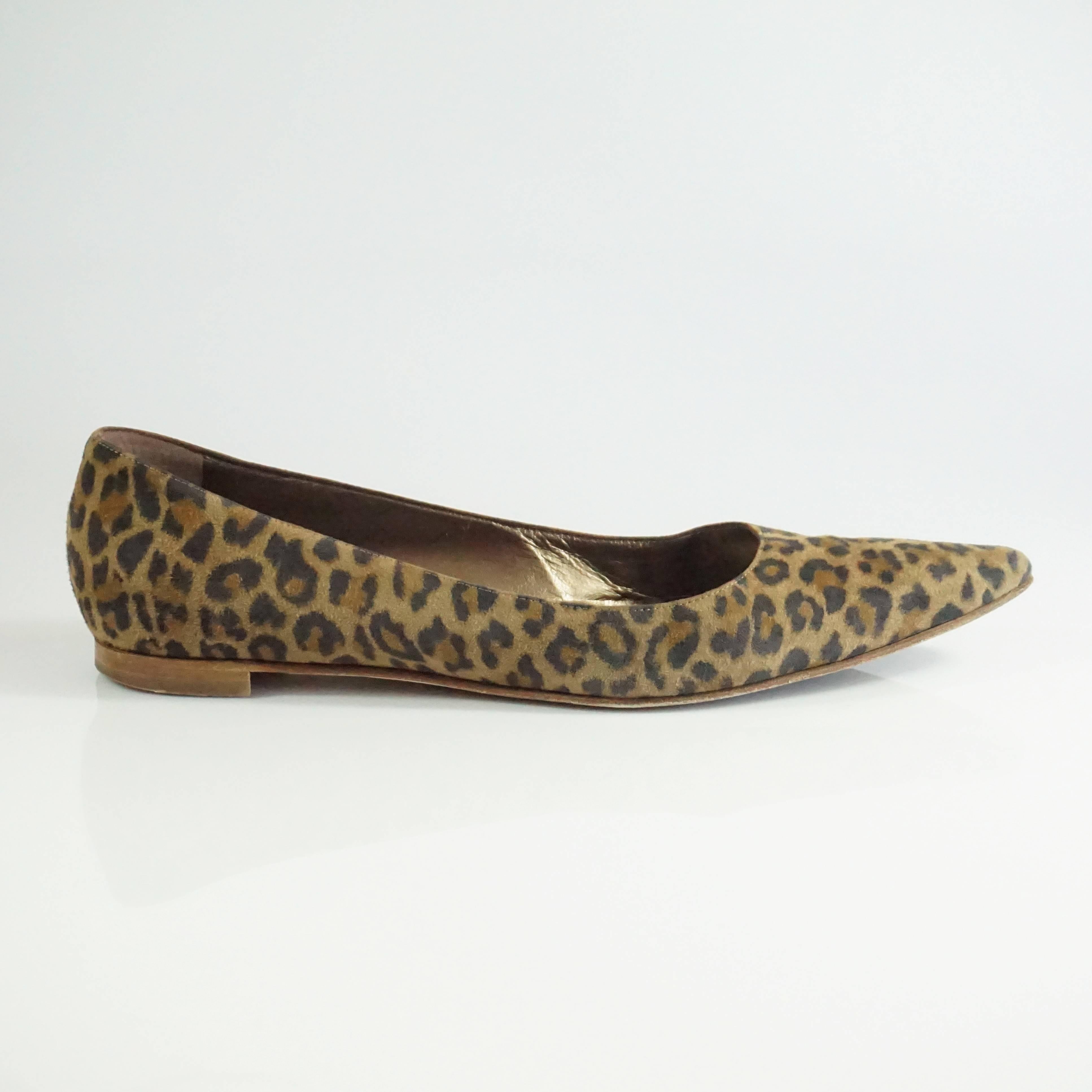 These funky Manolo Blahnik flats are suede and have an animal print on them. They are pointed toe and are in good condition with some bottom wear, and wear on the suede as seen in the images. Size 38.5

