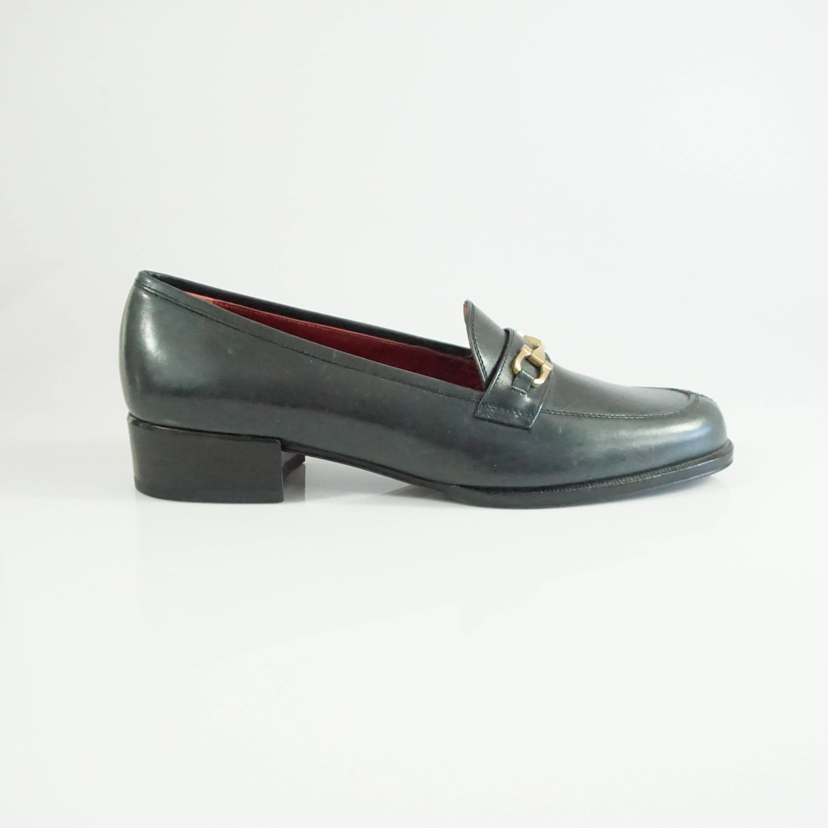 These Salvatore Ferragamo black leather loafers are a classic staple. They feature a soft leather material and a soft gold horse bit. The shoes are in good condition with some bottom wear and some scratches to the leather as seen in the last images.