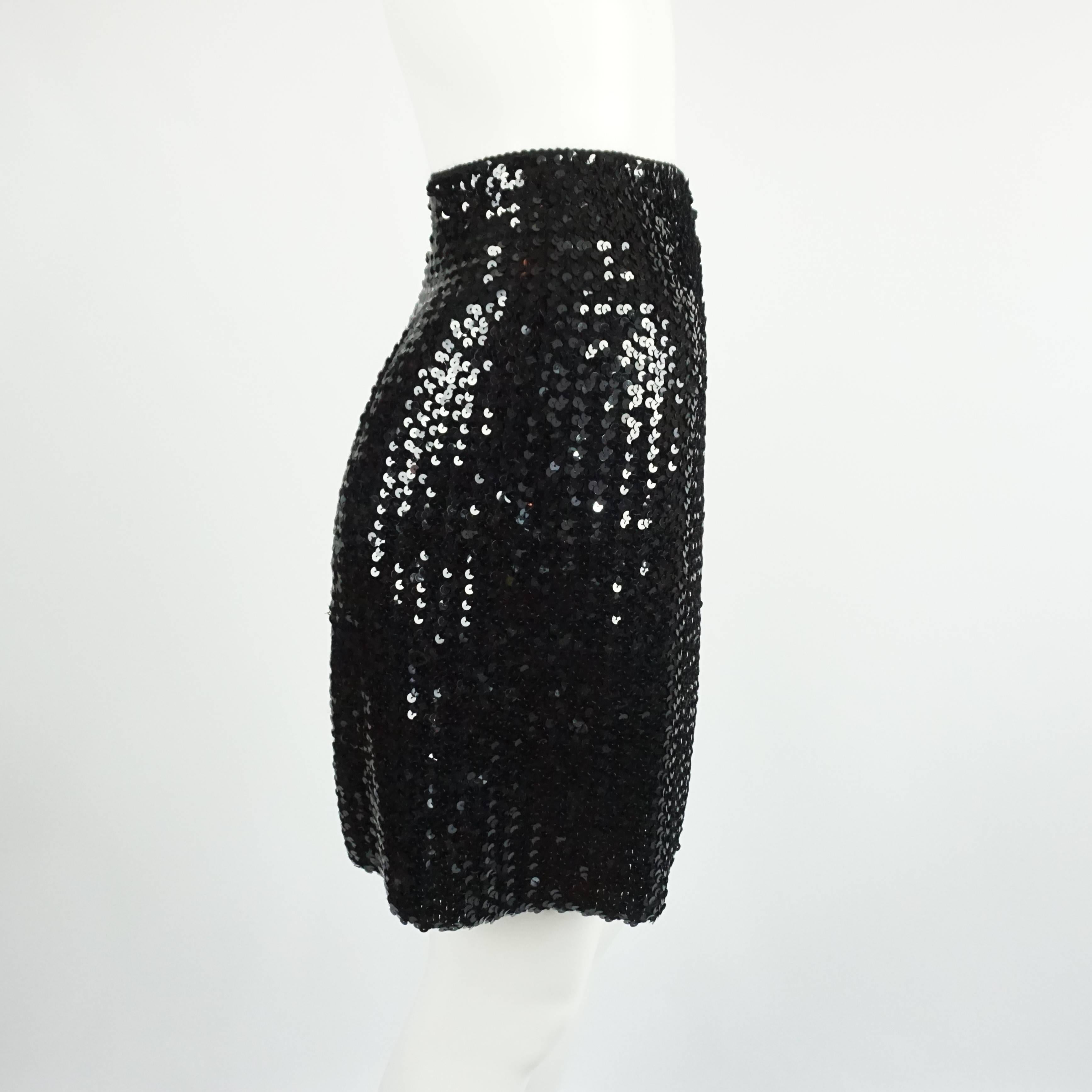 This 1990's Vintage Todd Oldham skirt is made of a knitted material with sequins all over. The fabric stretches allowing it to fit several sizes. The piece is in very good vintage condition. Size S, circa 1990's. 

Measurements
Waist: 28-30
